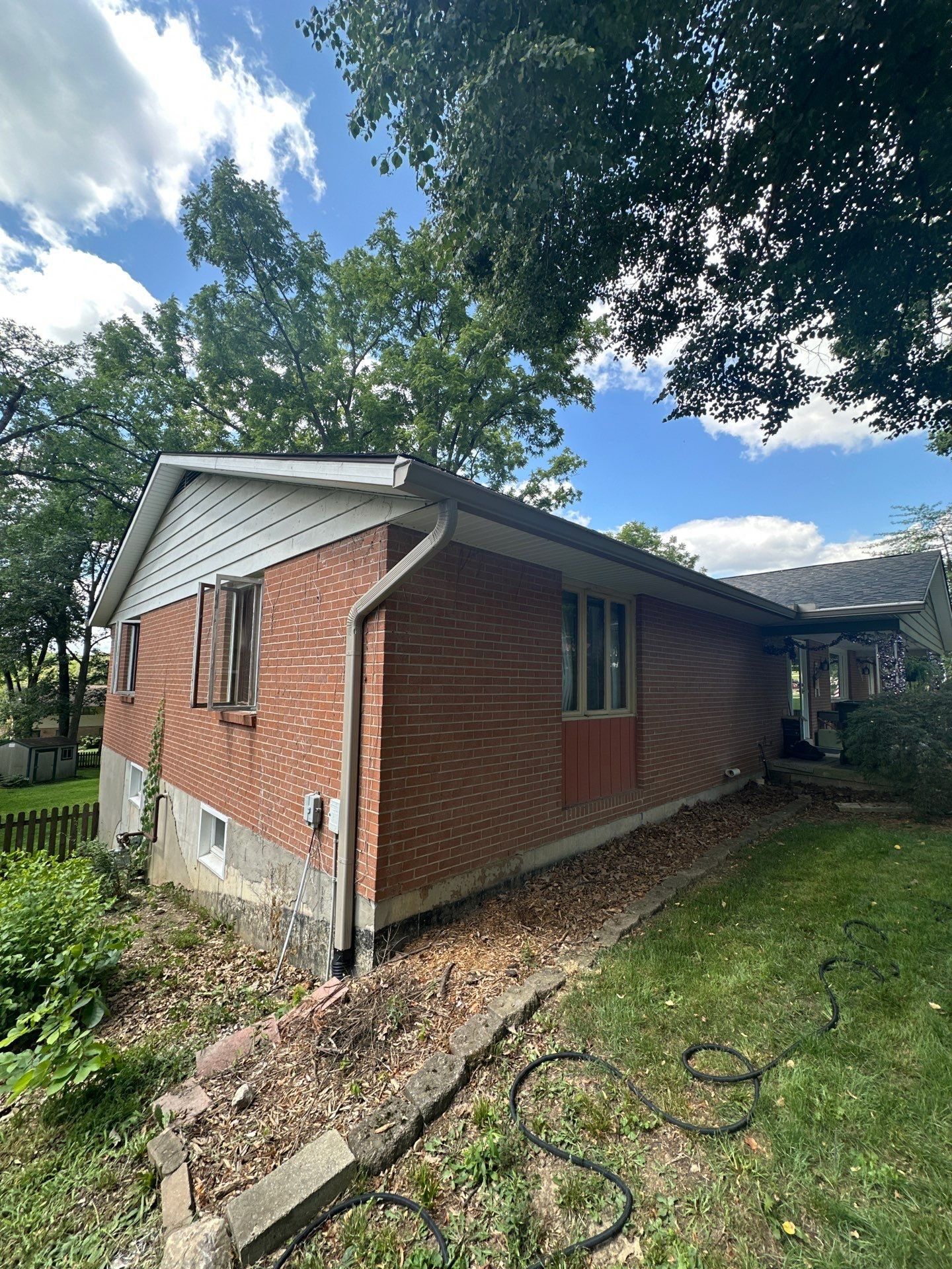 New seamless gutter and downspout on the side of the house, Beavercreek, Ohio.