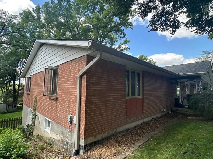 New seamless gutter and downspout on the side of the house, Beavercreek, Ohio.