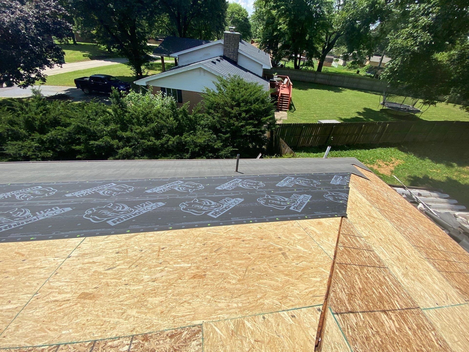 Synthetic underlayment rolled out along the lower edge of the roof, Beavercreek, Ohio.