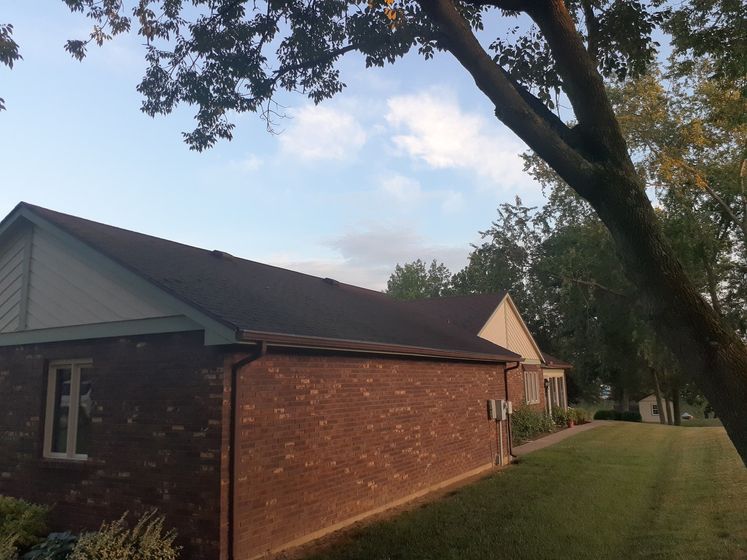 Long brick side wall and old roofline seen from the side yard, Jamestown, Ohio.