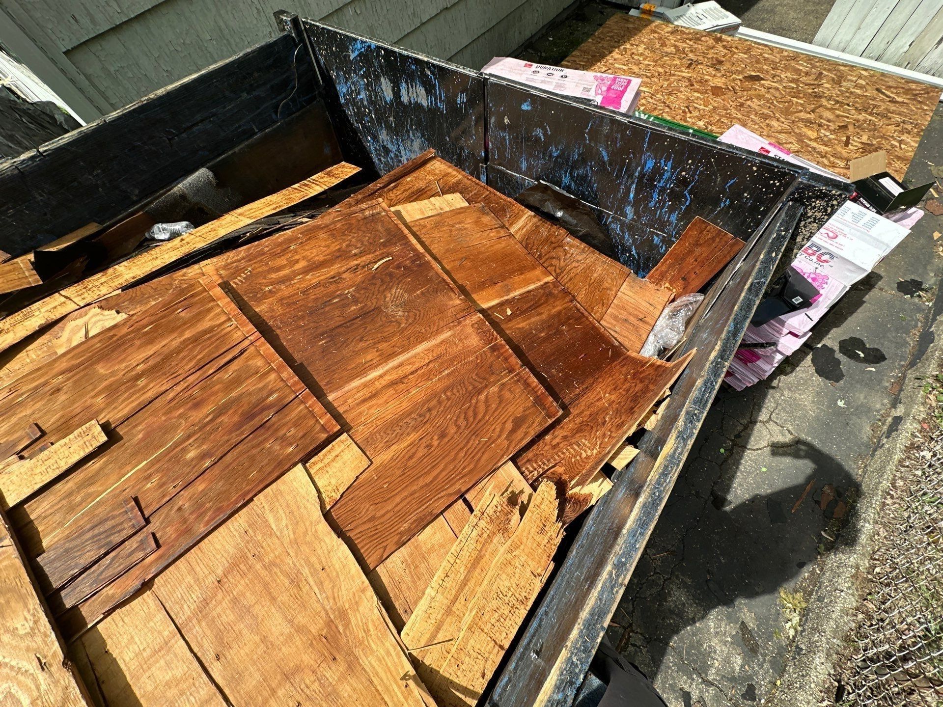 Pieces of the old delaminated sheathing in the dumpster, Dayton, Ohio.