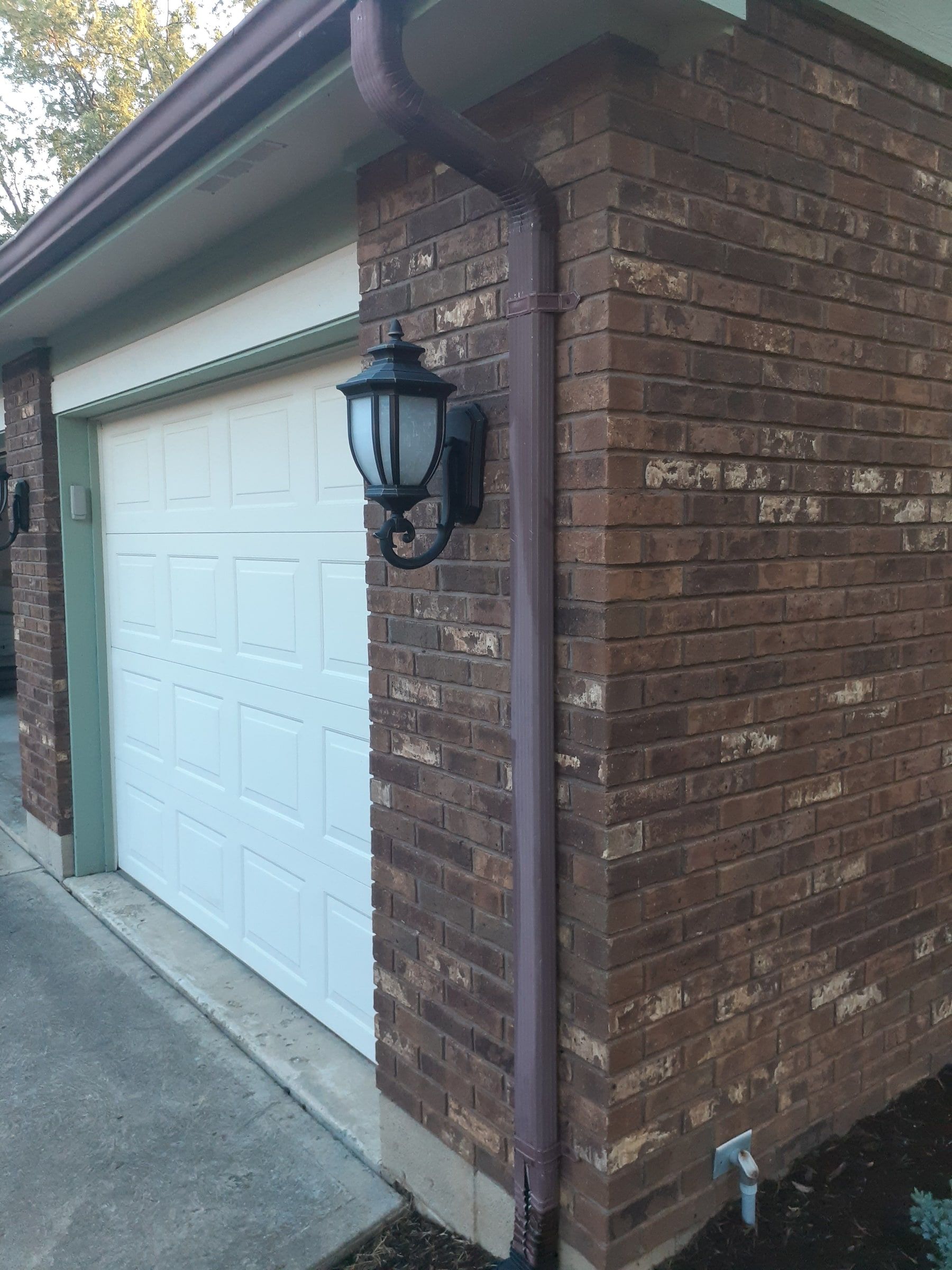 Corner of the garage with its downspout and lamp under the old eave, Jamestown, Ohio.