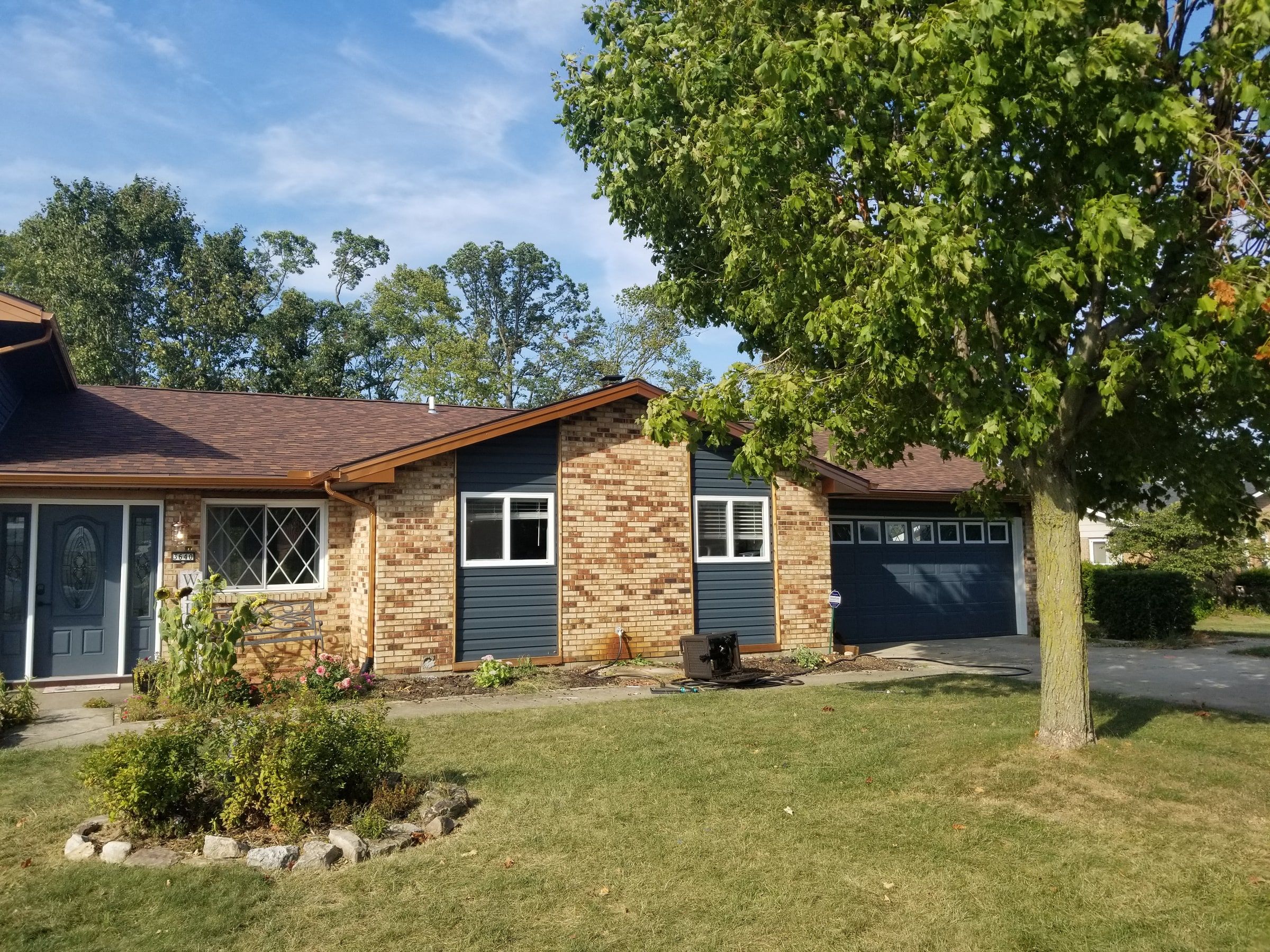 The finished front of the house with its blue-gray garage door, Beavercreek, Ohio.
