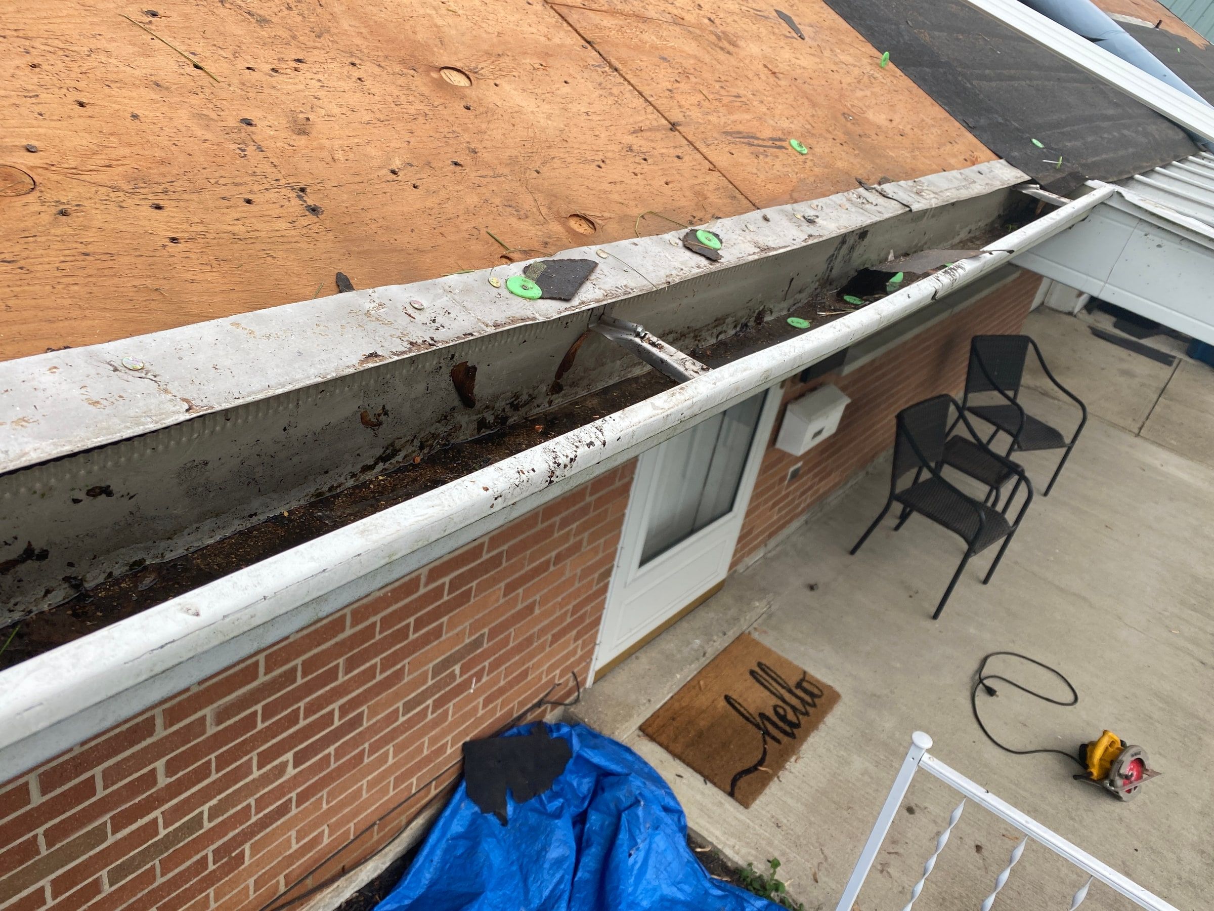 The old gutter full of shingle grit along the eave above the patio, Huber Heights, Ohio.