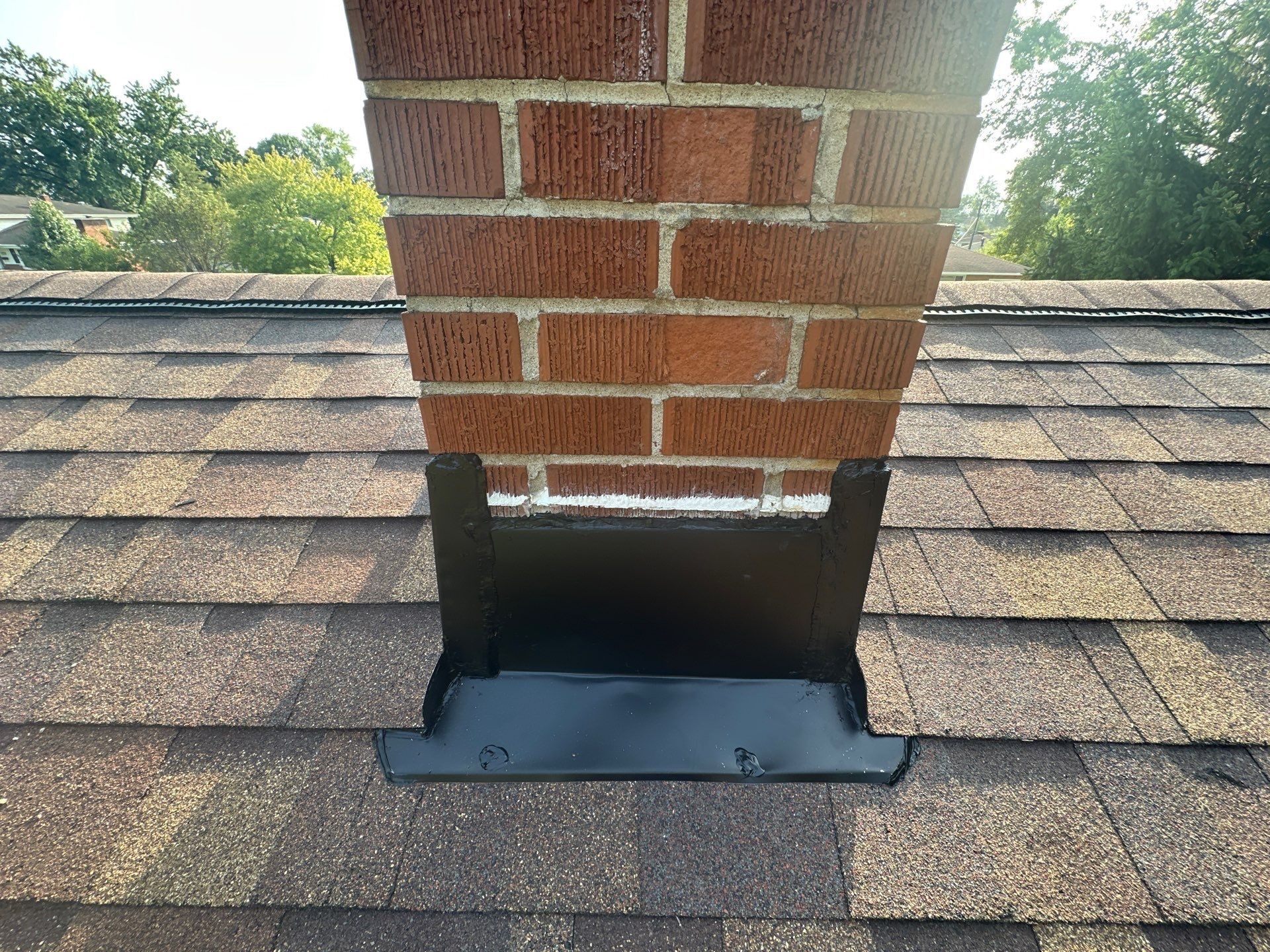 New chimney flashing fitted below the brick, Fairborn, Ohio.