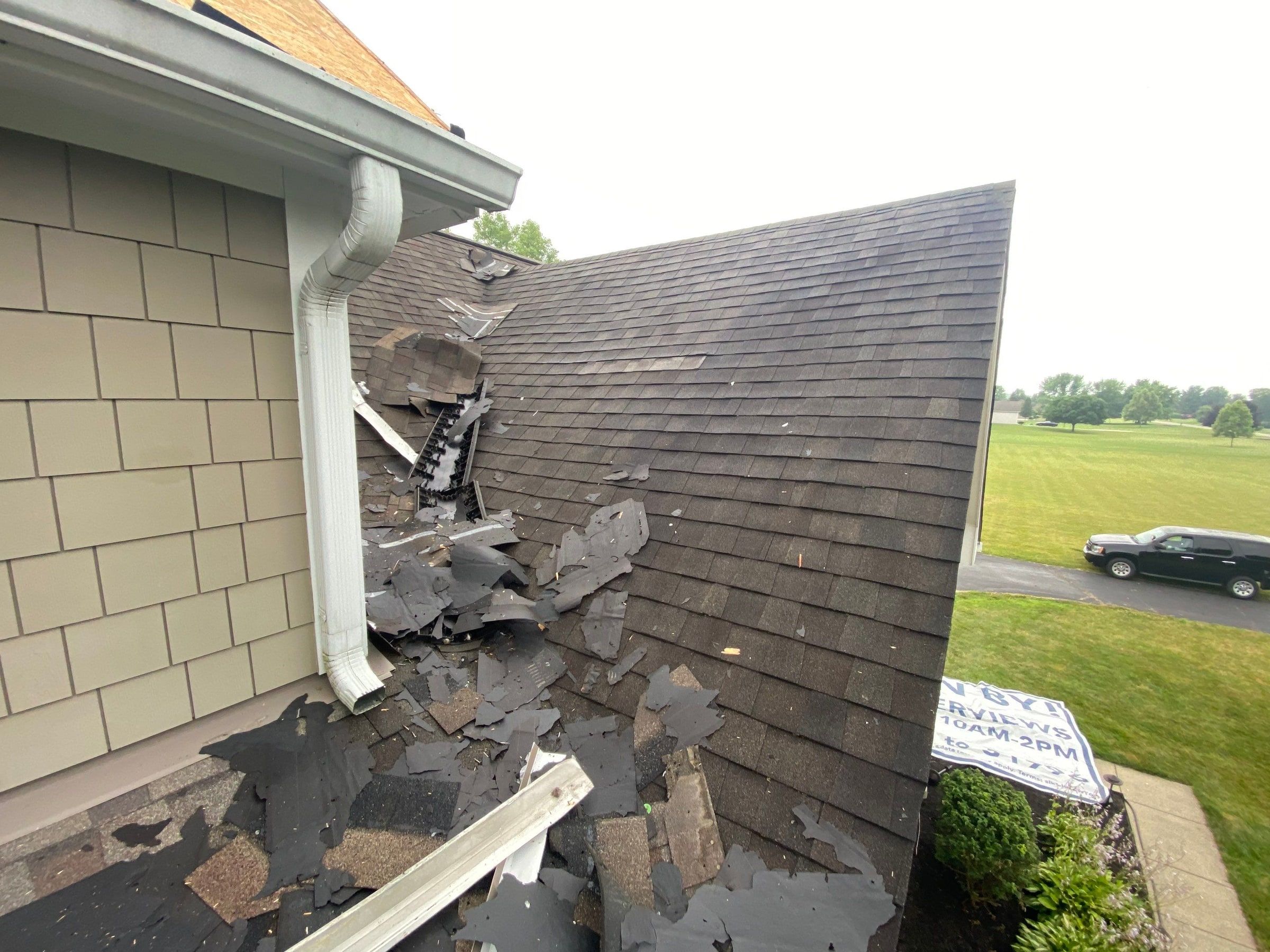 Old shingles torn loose where the lower roof meets the siding, Yellow Springs, Ohio.