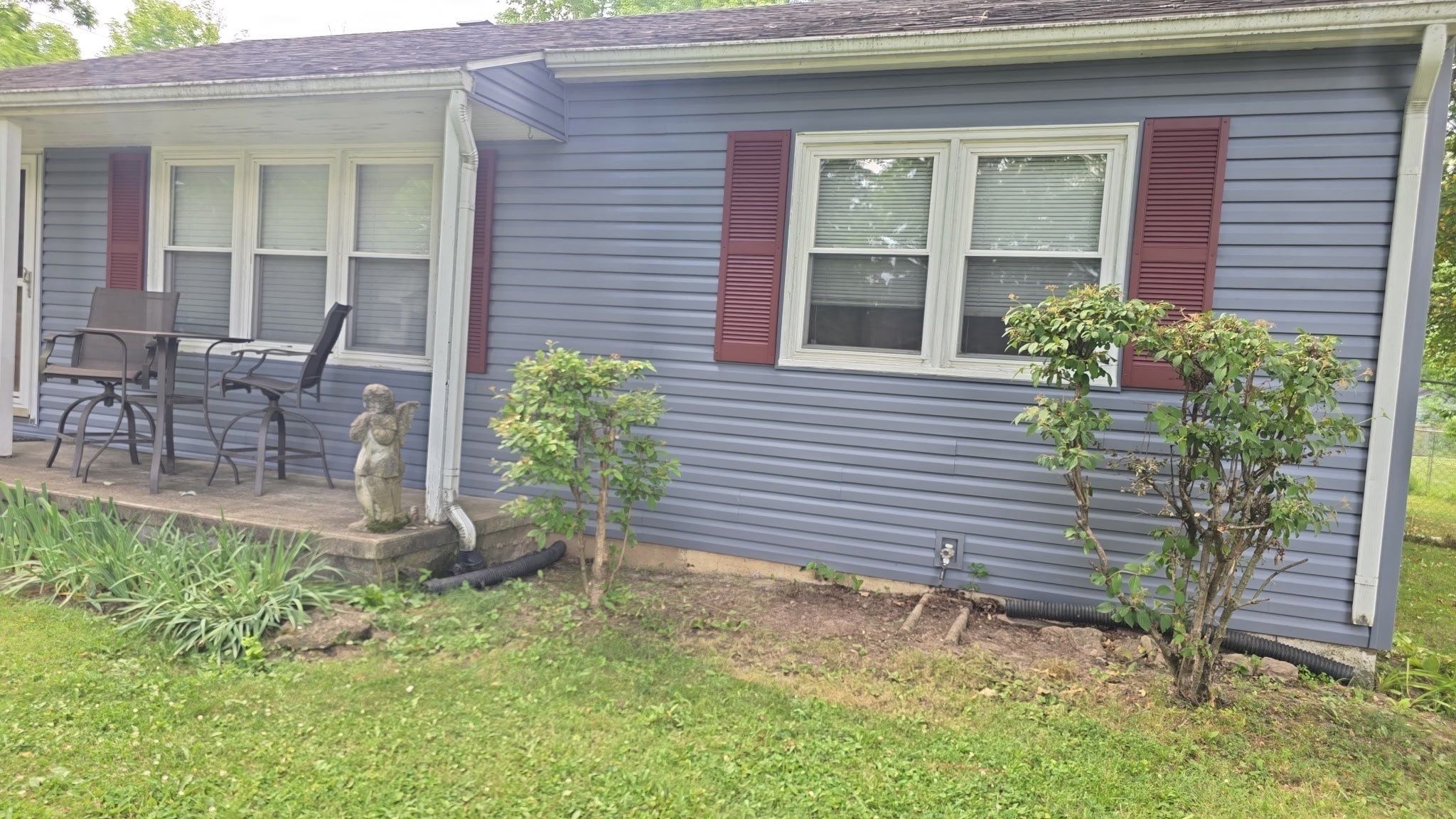 Front elevation, porch and red shutters