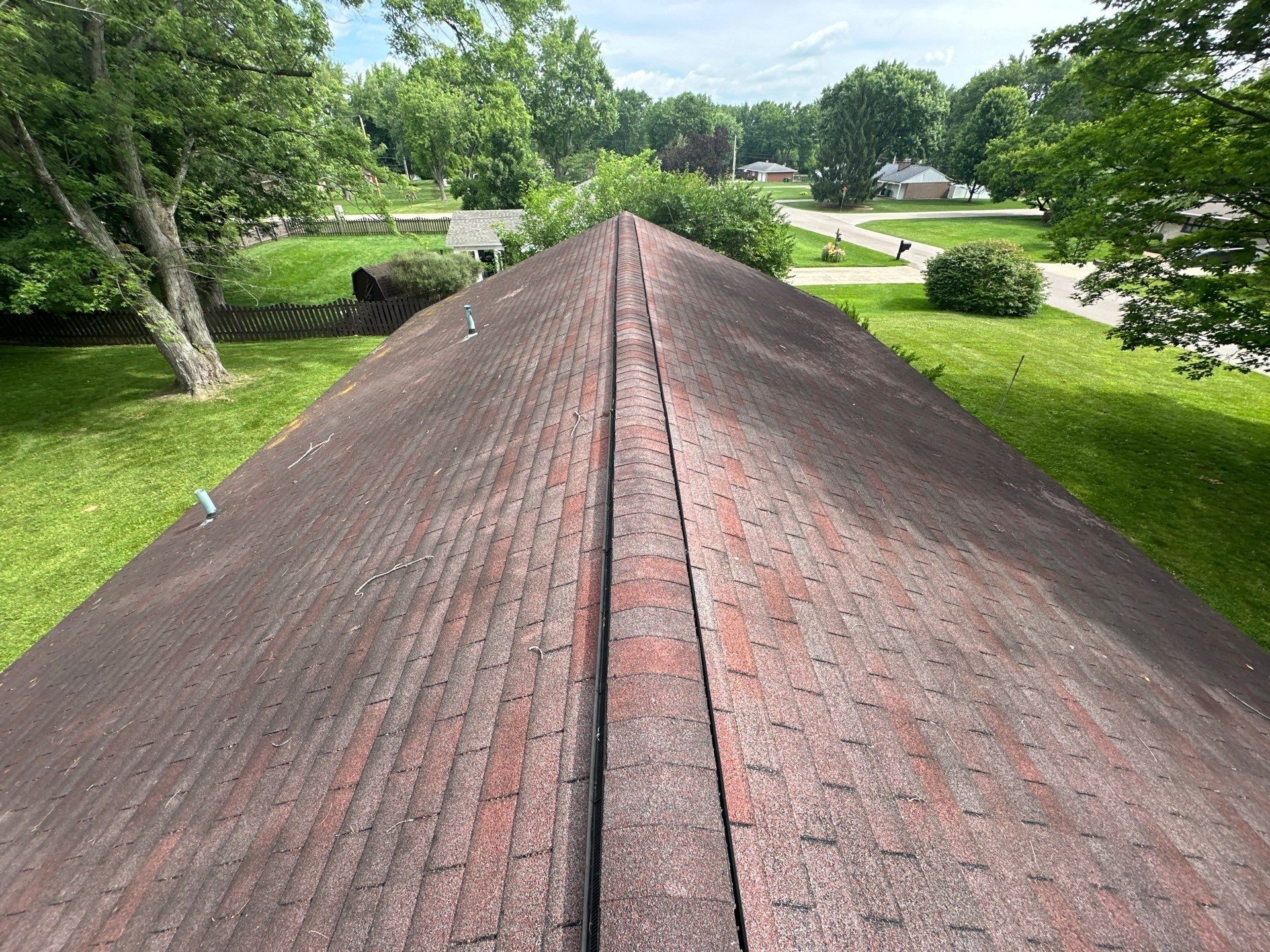 The worn three-tab shingles along the house ridge, Beavercreek, Ohio.