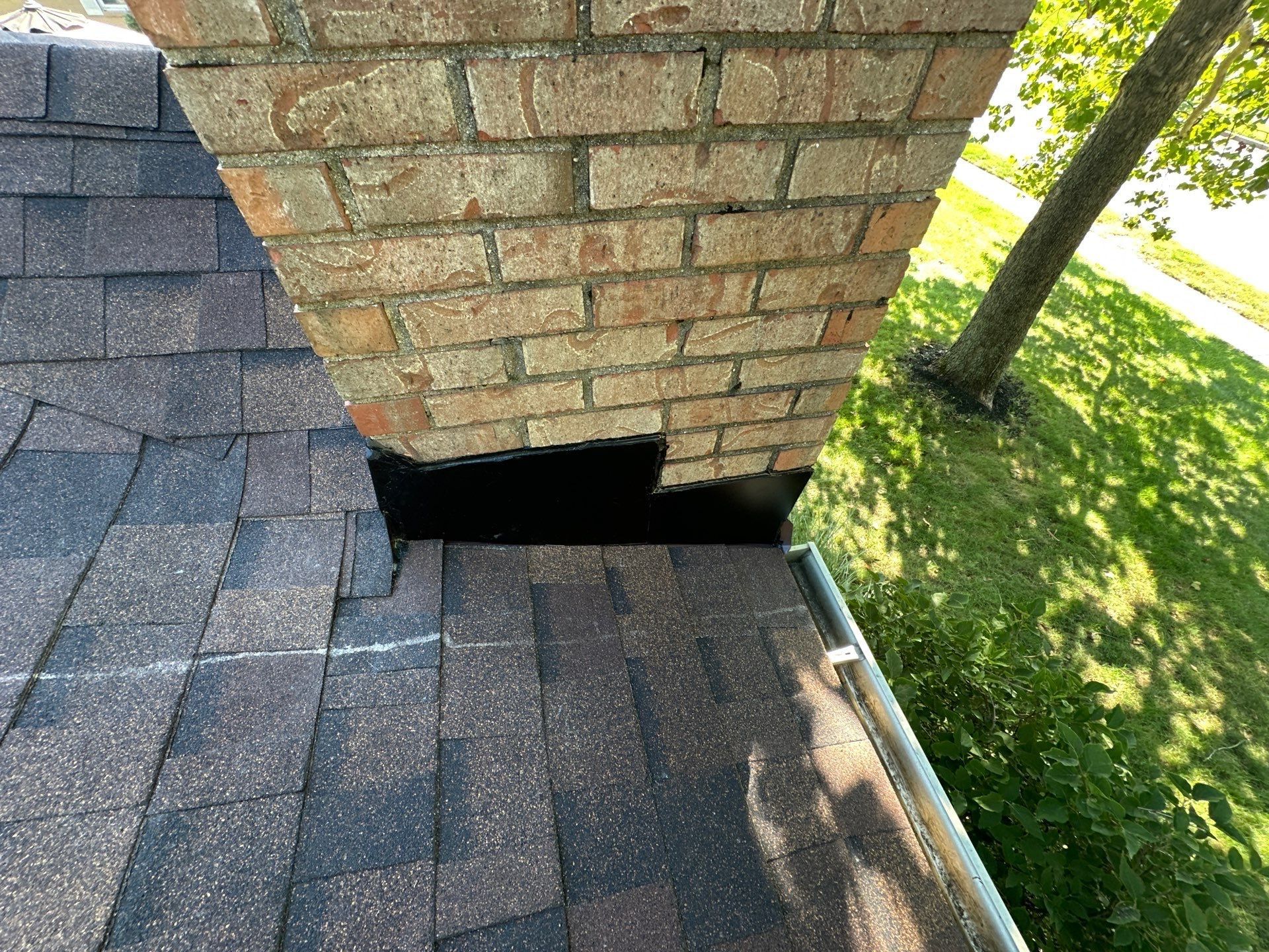 New flashing along the bottom of the brick chimney, beside the gutter, Dayton, Ohio.