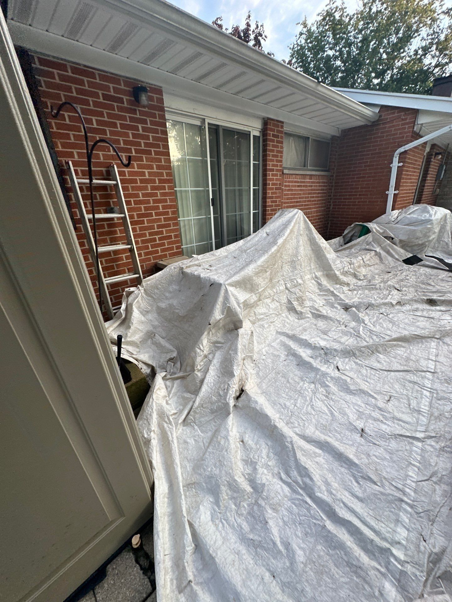 A tarp draped over the patio beside the sliding door, Beavercreek, Ohio.