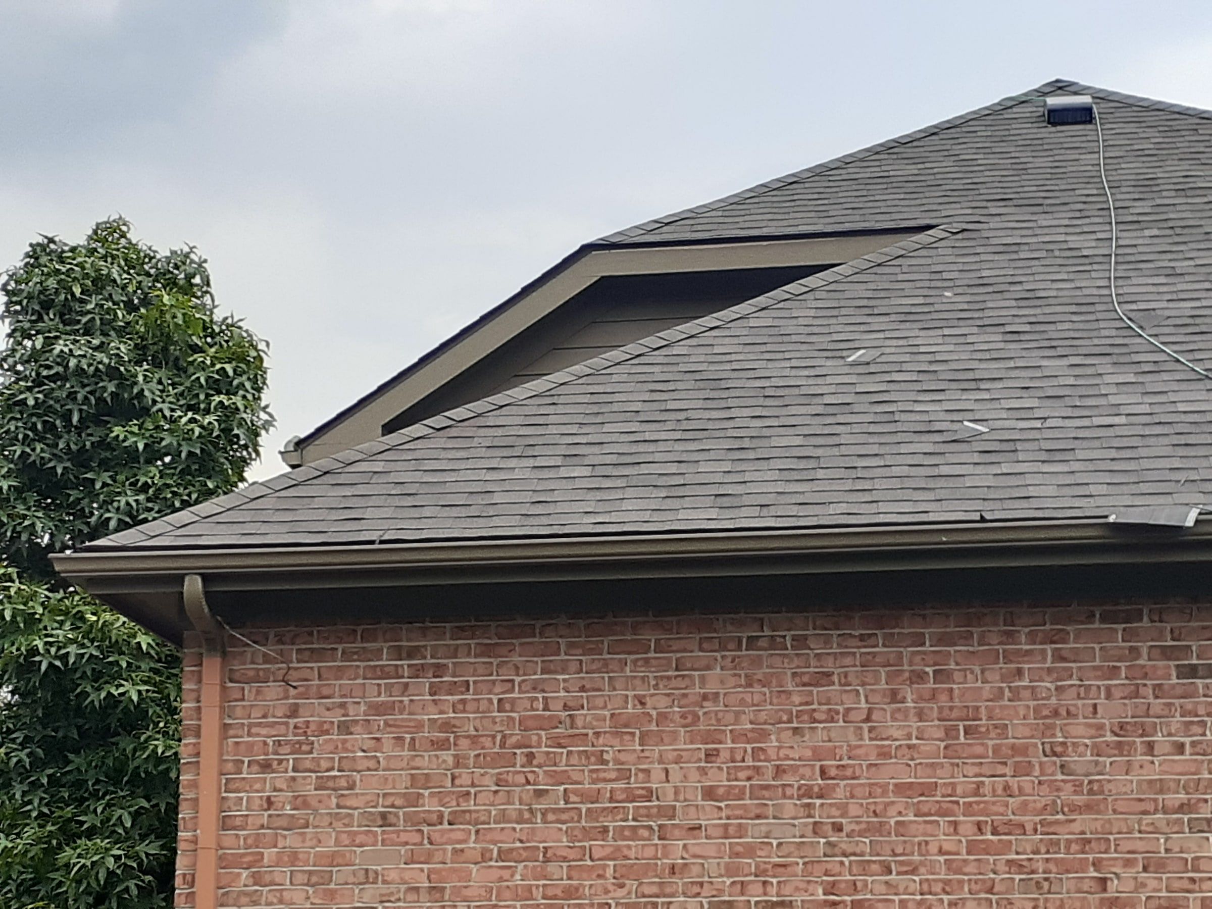 Shingle roof and brick gable end