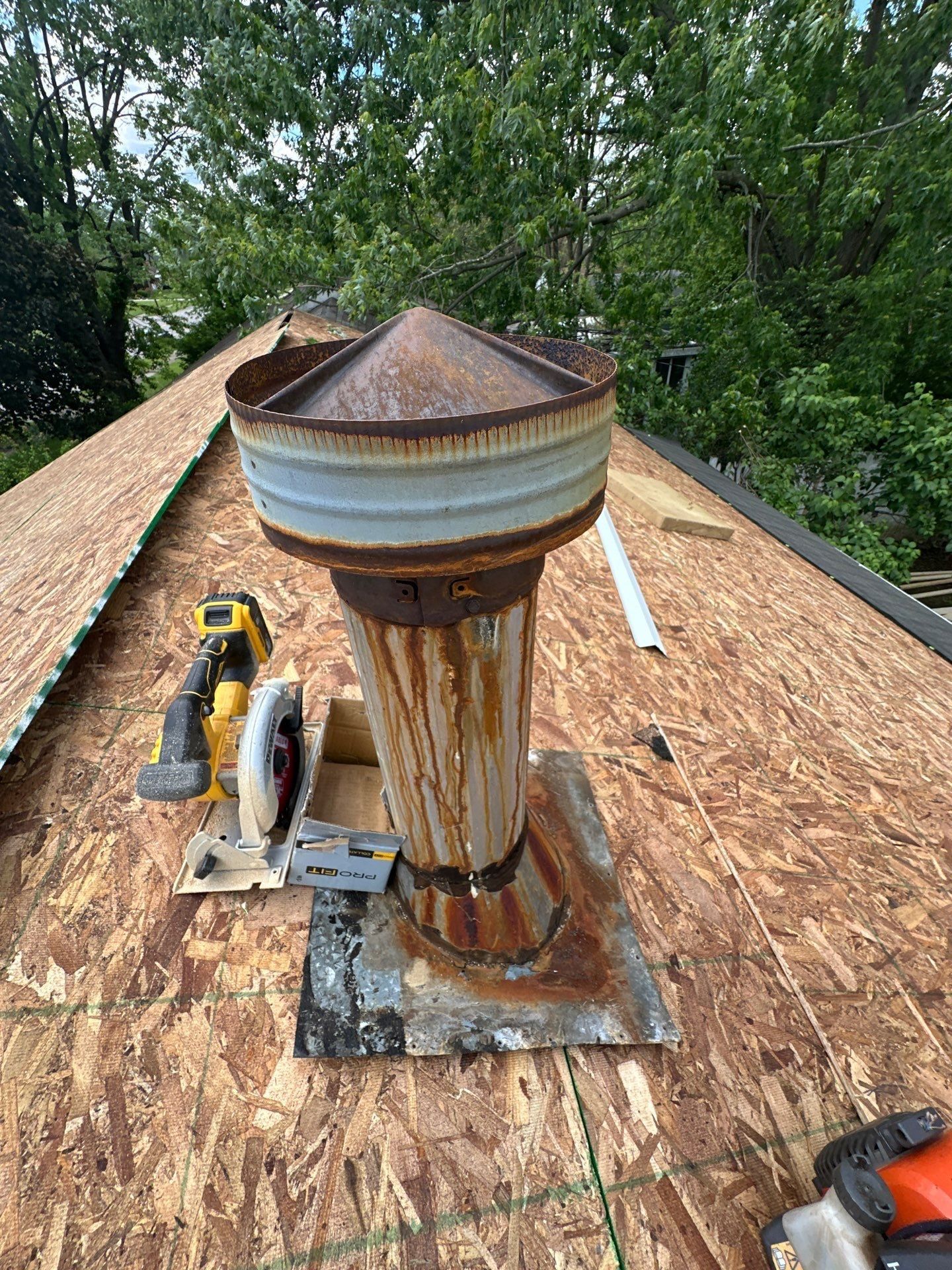 Flue, rain cap and pan on decking