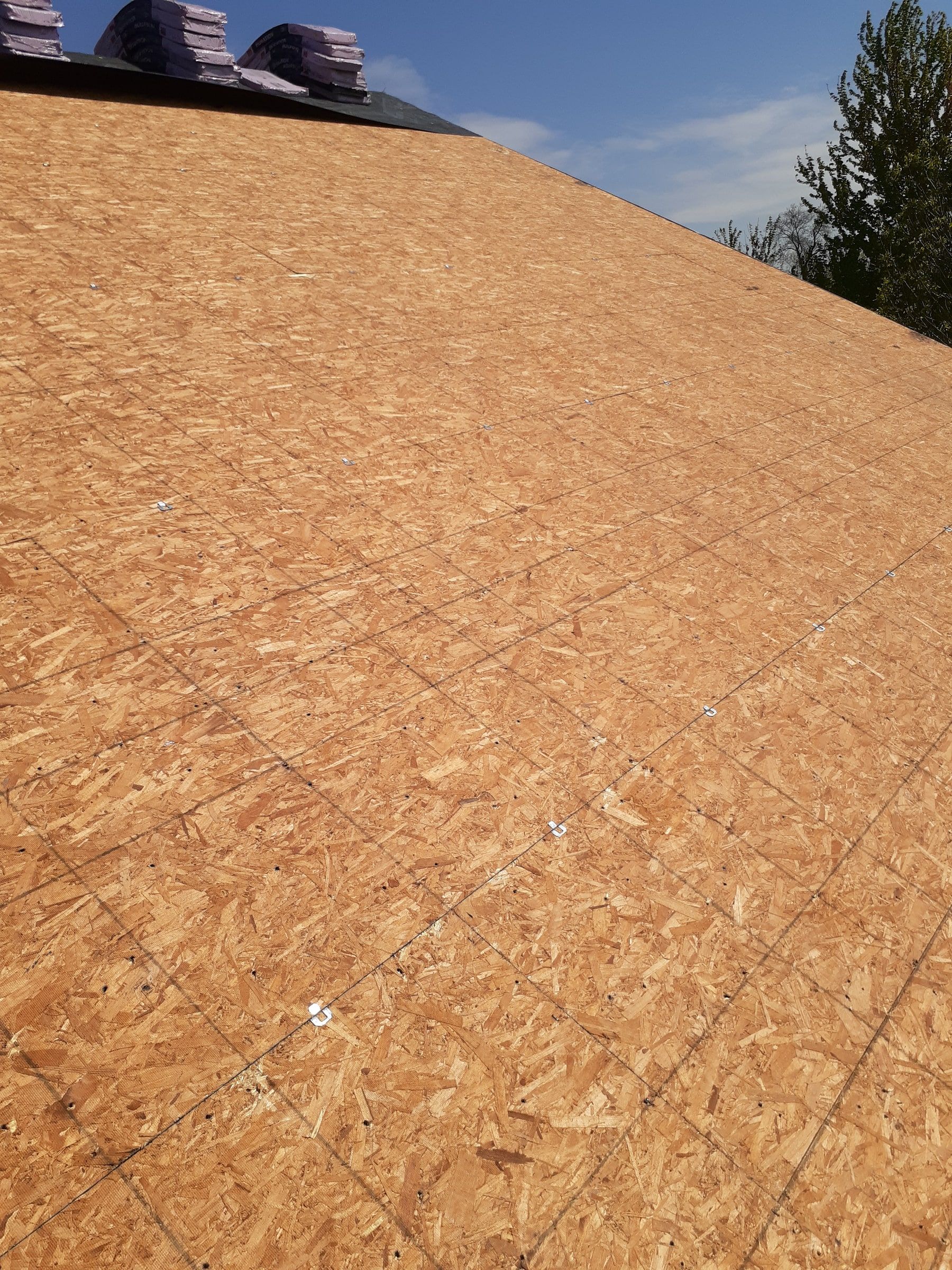 New sheathing across the roof deck