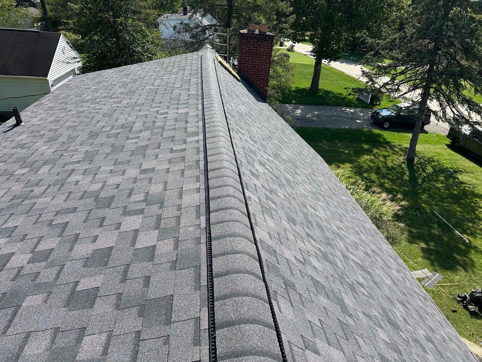 Ridge vent along the finished roof, beside the chimney, Beavercreek, Ohio.