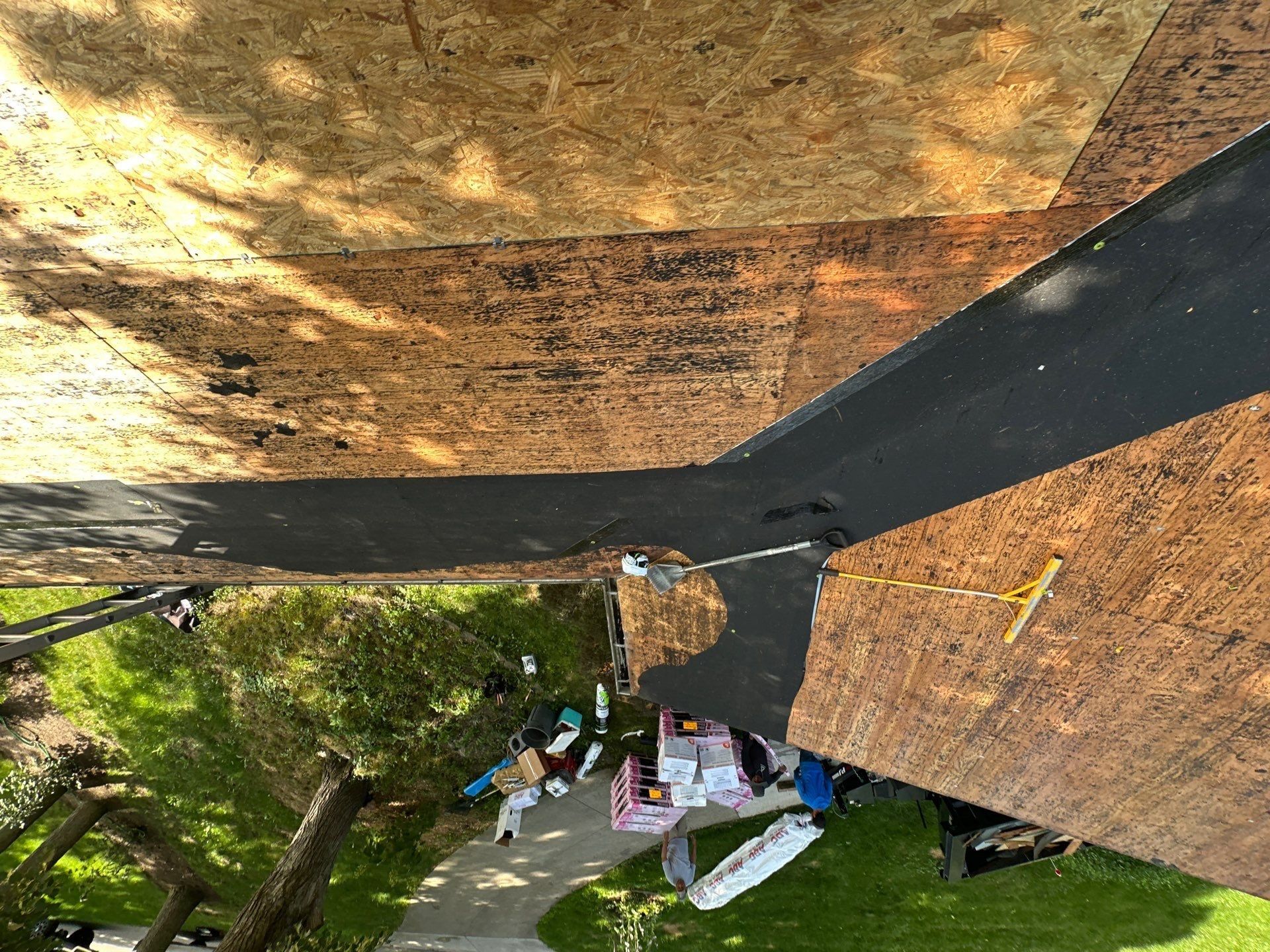 Stripped deck at the eave above the drive
