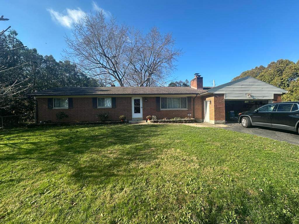 Brick ranch under a bare tree