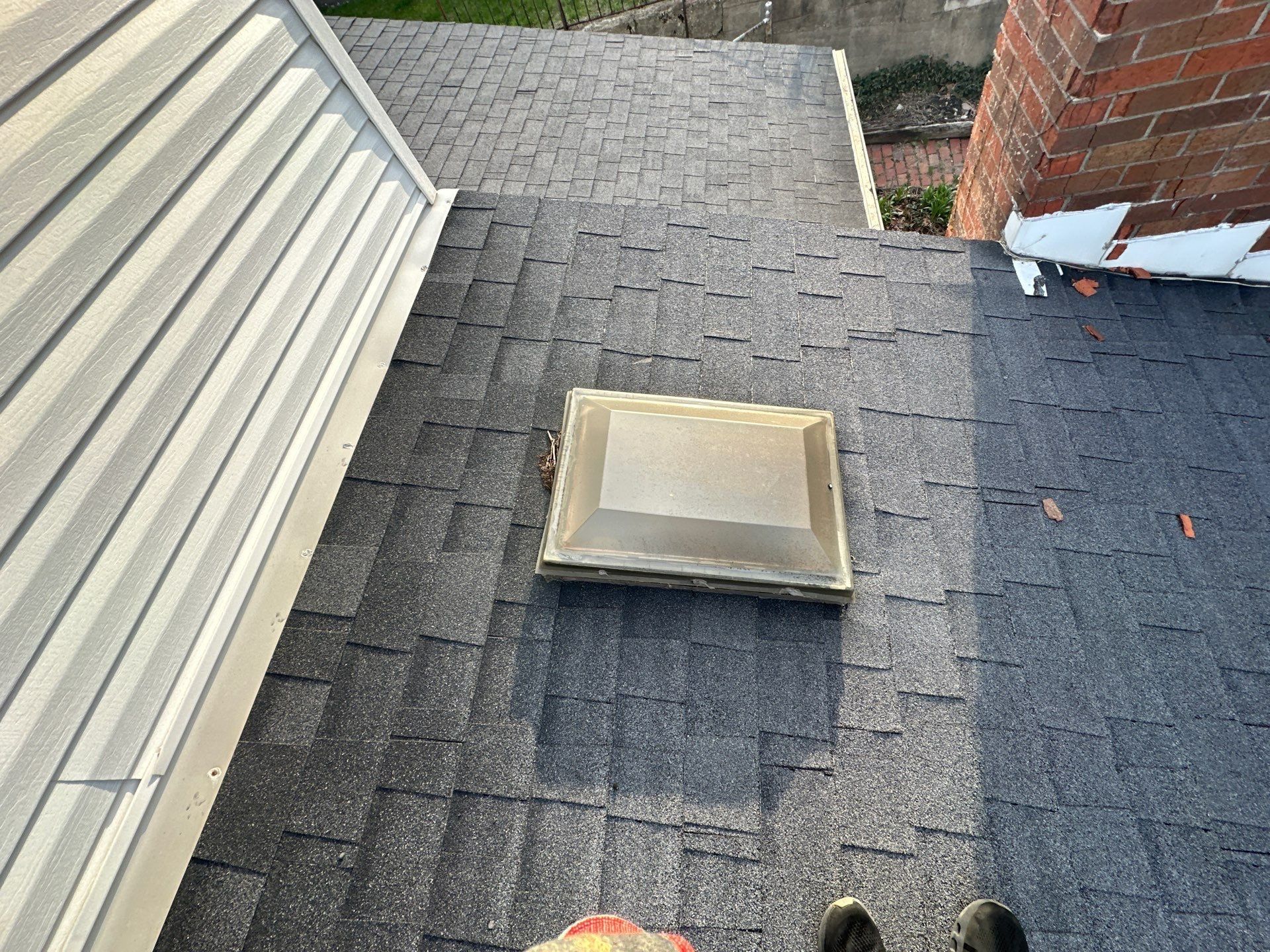 The old skylight on the shingle roof beside the brick chimney, Dayton, Ohio.