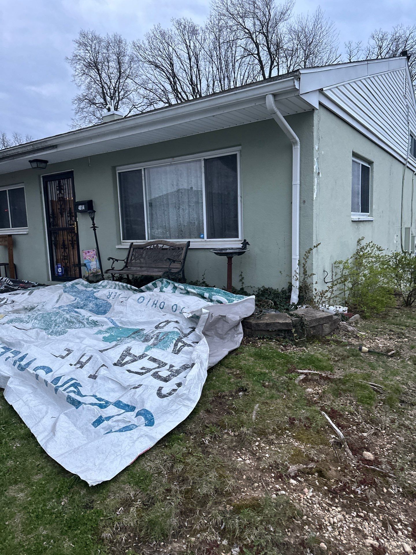 Tarps covering the lawn and beds along the front of the house, Dayton, Ohio.