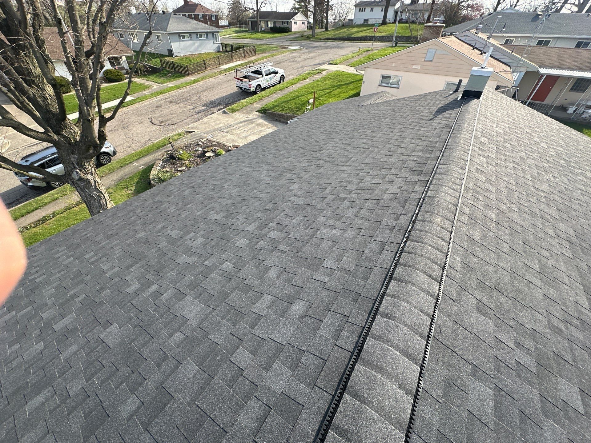 The finished Owens Corning Duration roof and ridge vent over the street, Dayton, Ohio.
