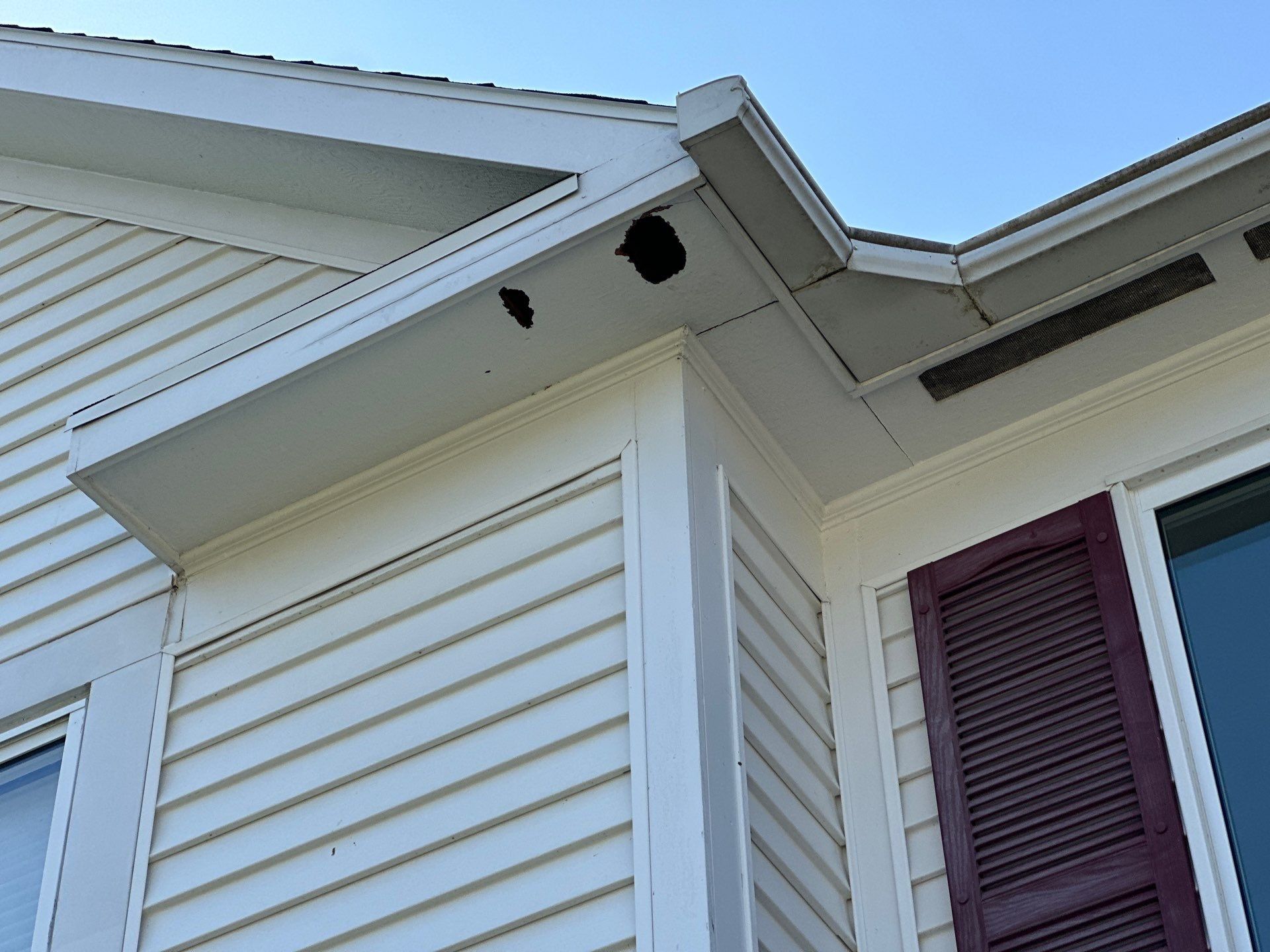 Trim board above a shuttered window