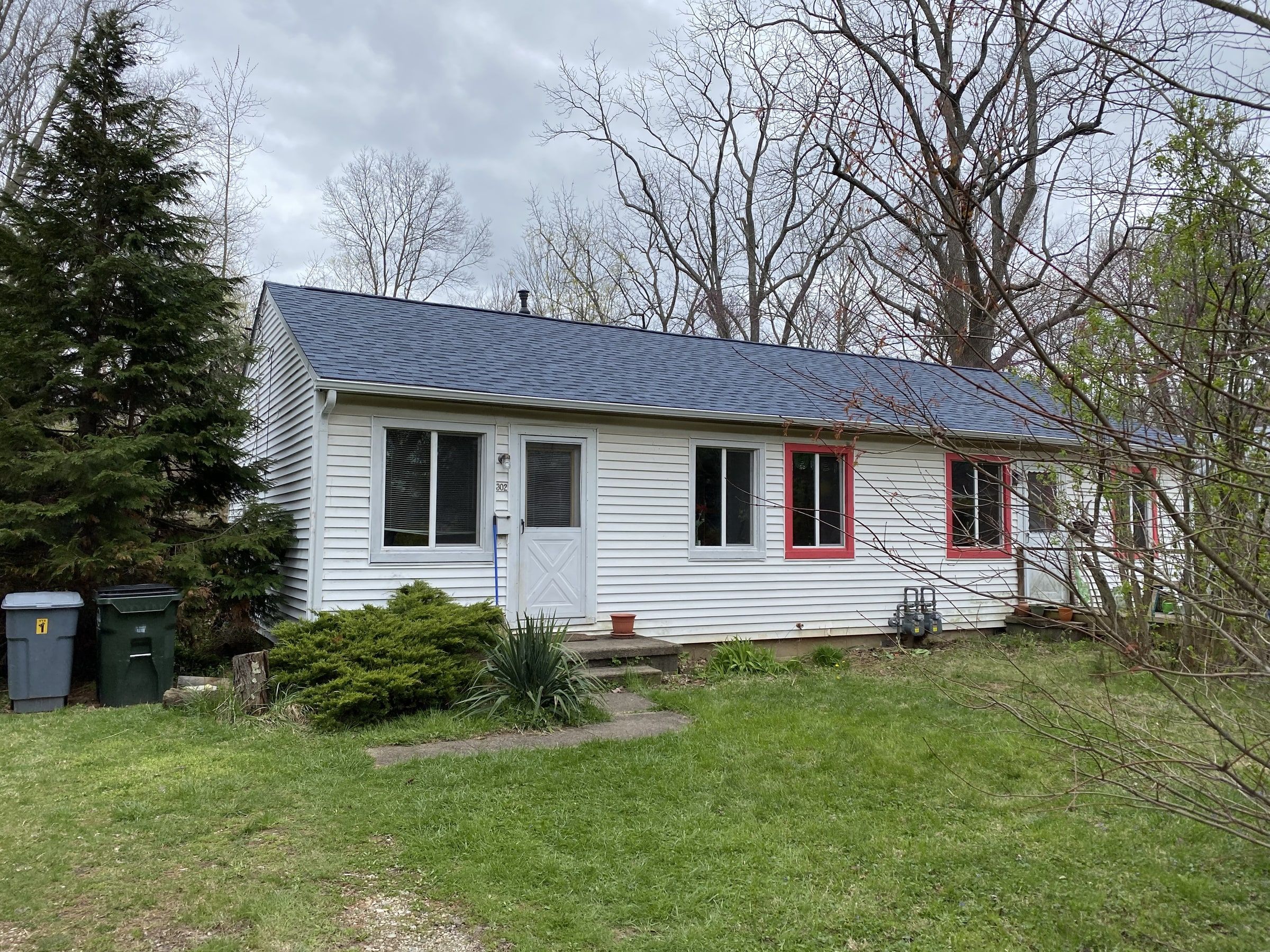 The front of the white ranch house under its new roof, two days after the work, Yellow Springs, Ohio.
