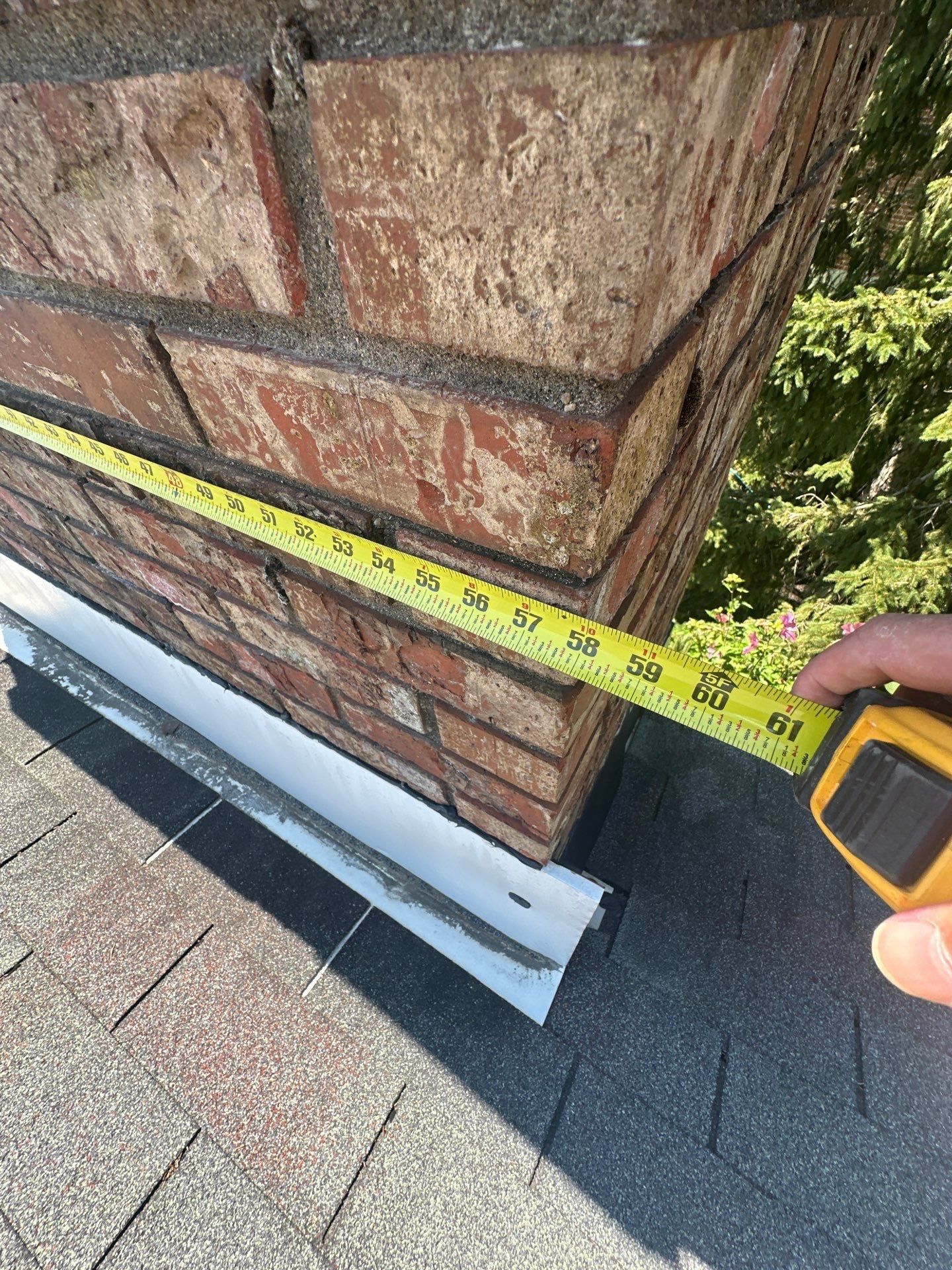 A tape measure along the long side of the chimney, above the old flashing, West Carrollton, Ohio.