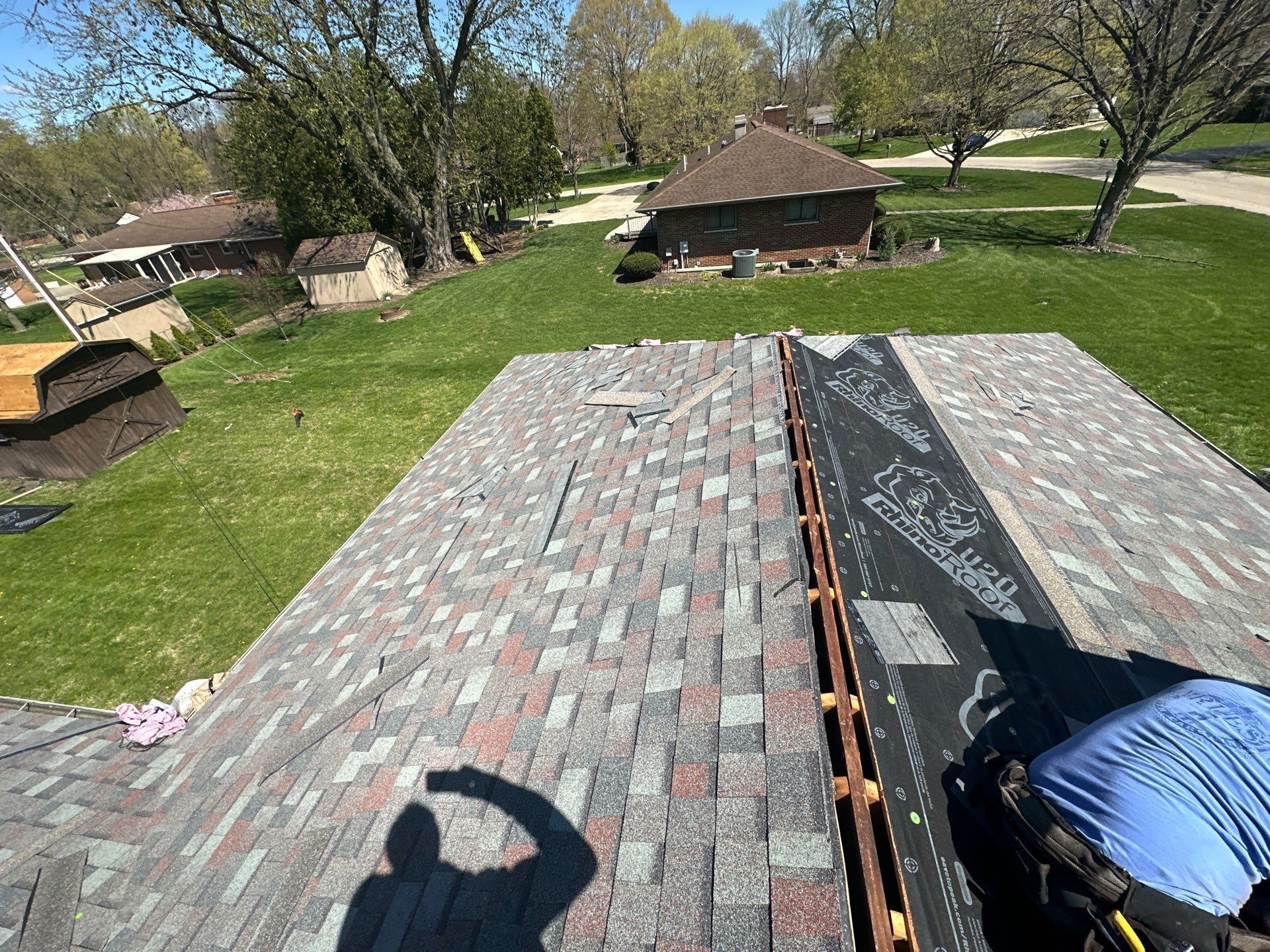 One side shingled while the other slope still shows underlayment, Beavercreek, Ohio.
