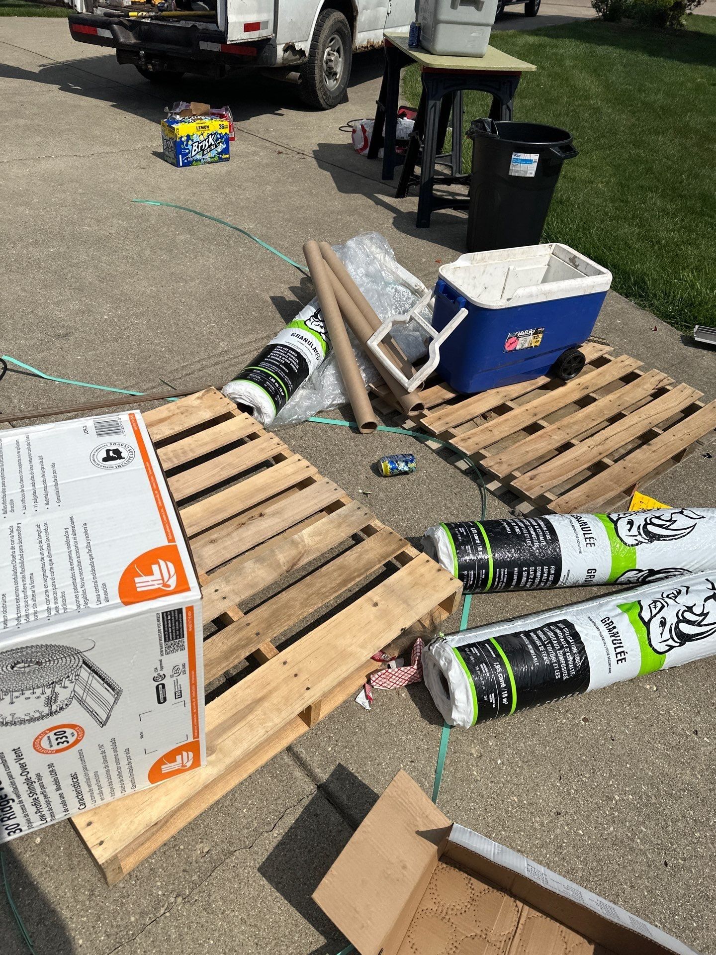 Rolls of underlayment, a box of nails and other supplies on the driveway, Beavercreek, Ohio.