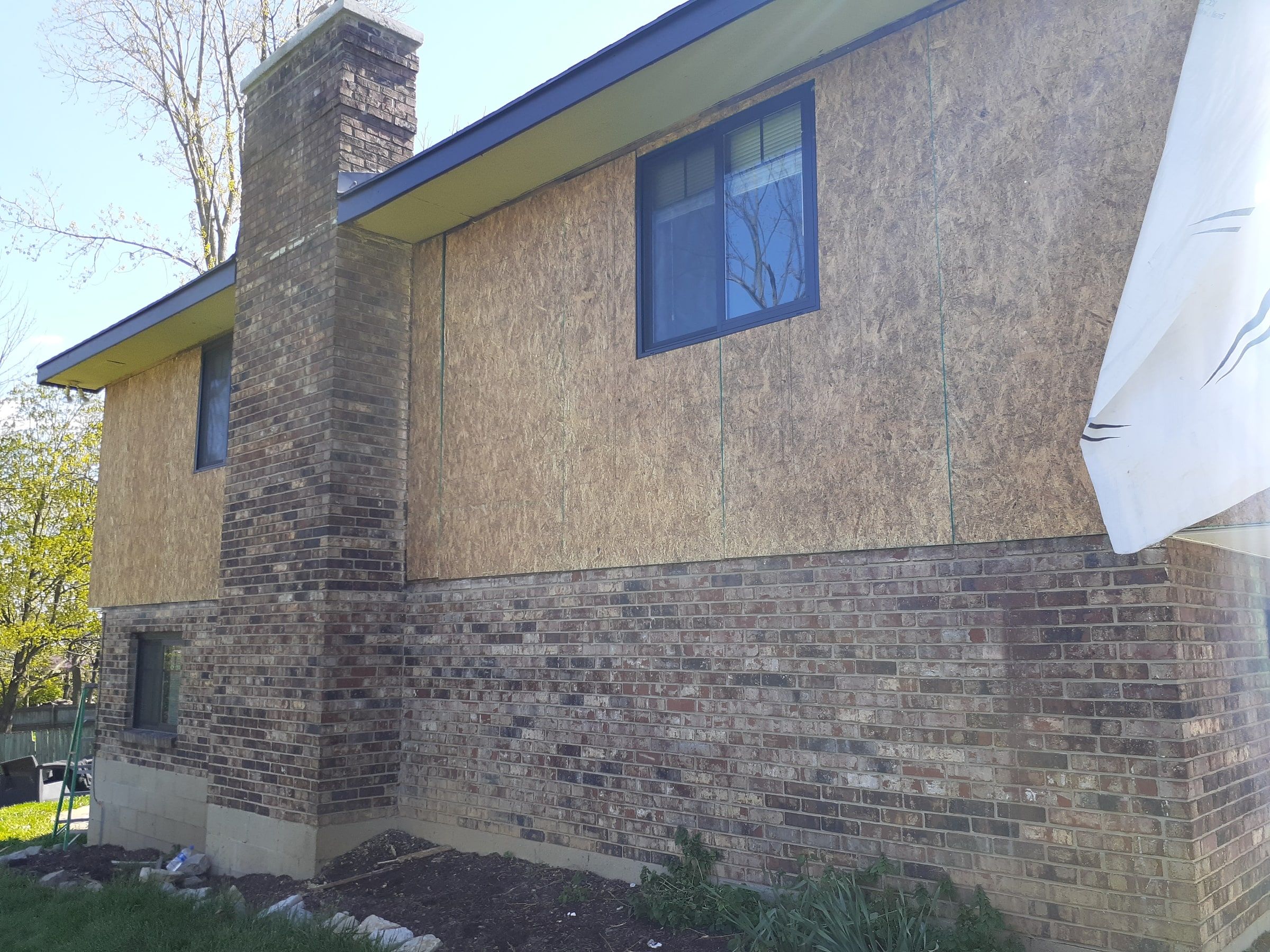OSB sheathing along the side wall beside the brick chimney, Beavercreek, Ohio.