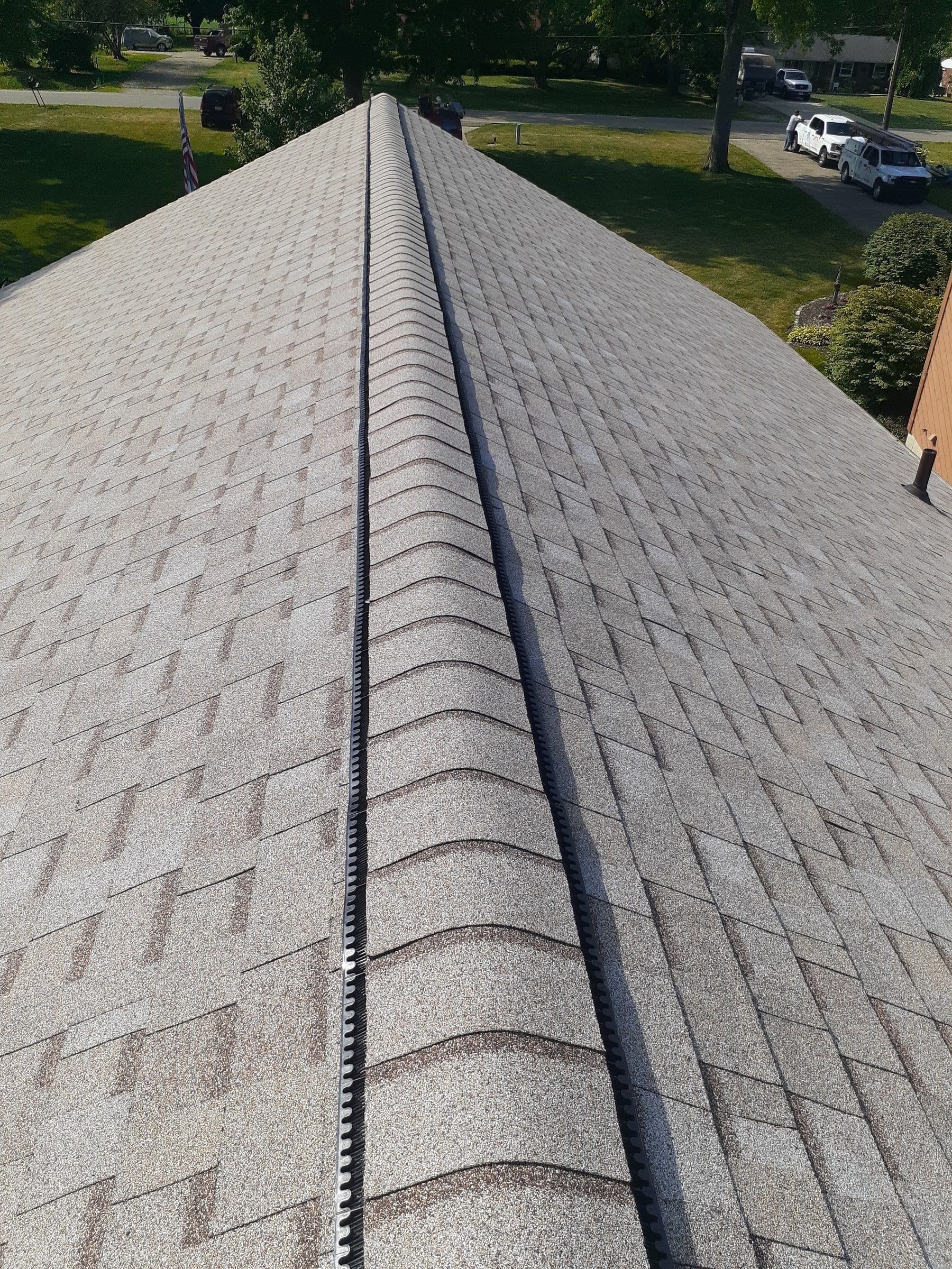 Close look at the ridge vent openings under the cap shingles, Jamestown, Ohio.