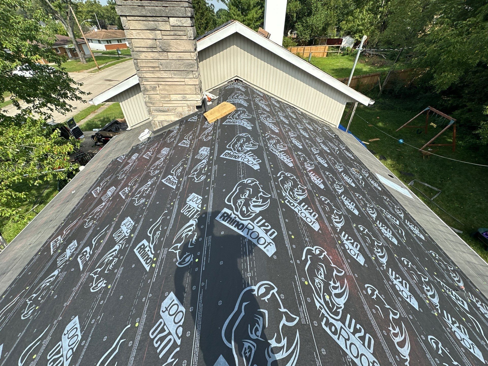 Synthetic underlayment up to the stone chimney and the second-story gable, Fairborn, Ohio.