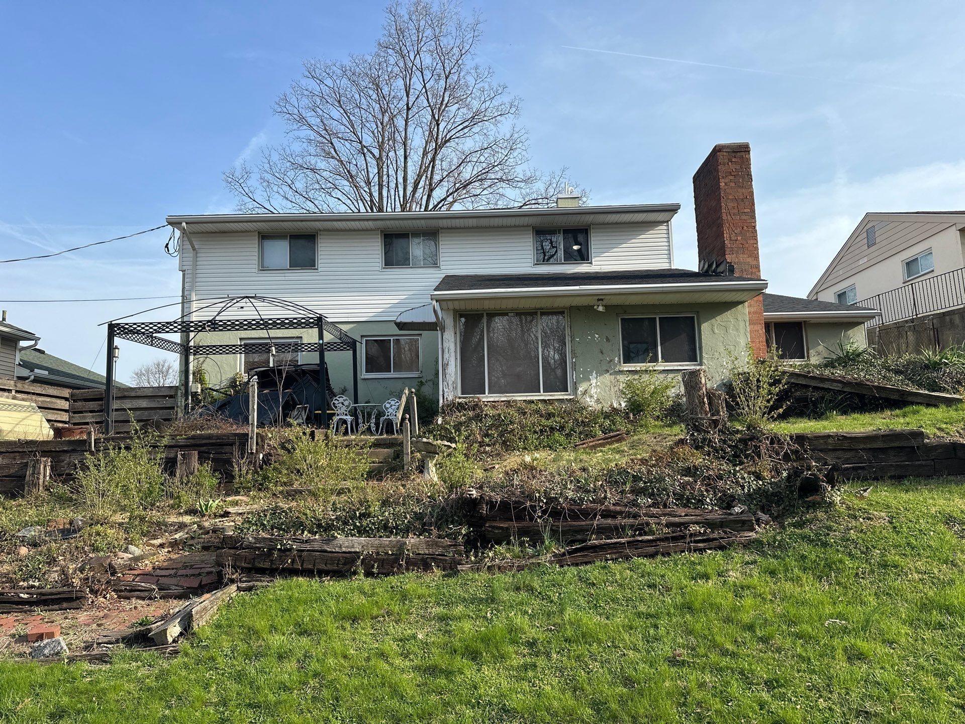 Two-story rear, pergola frame and beds
