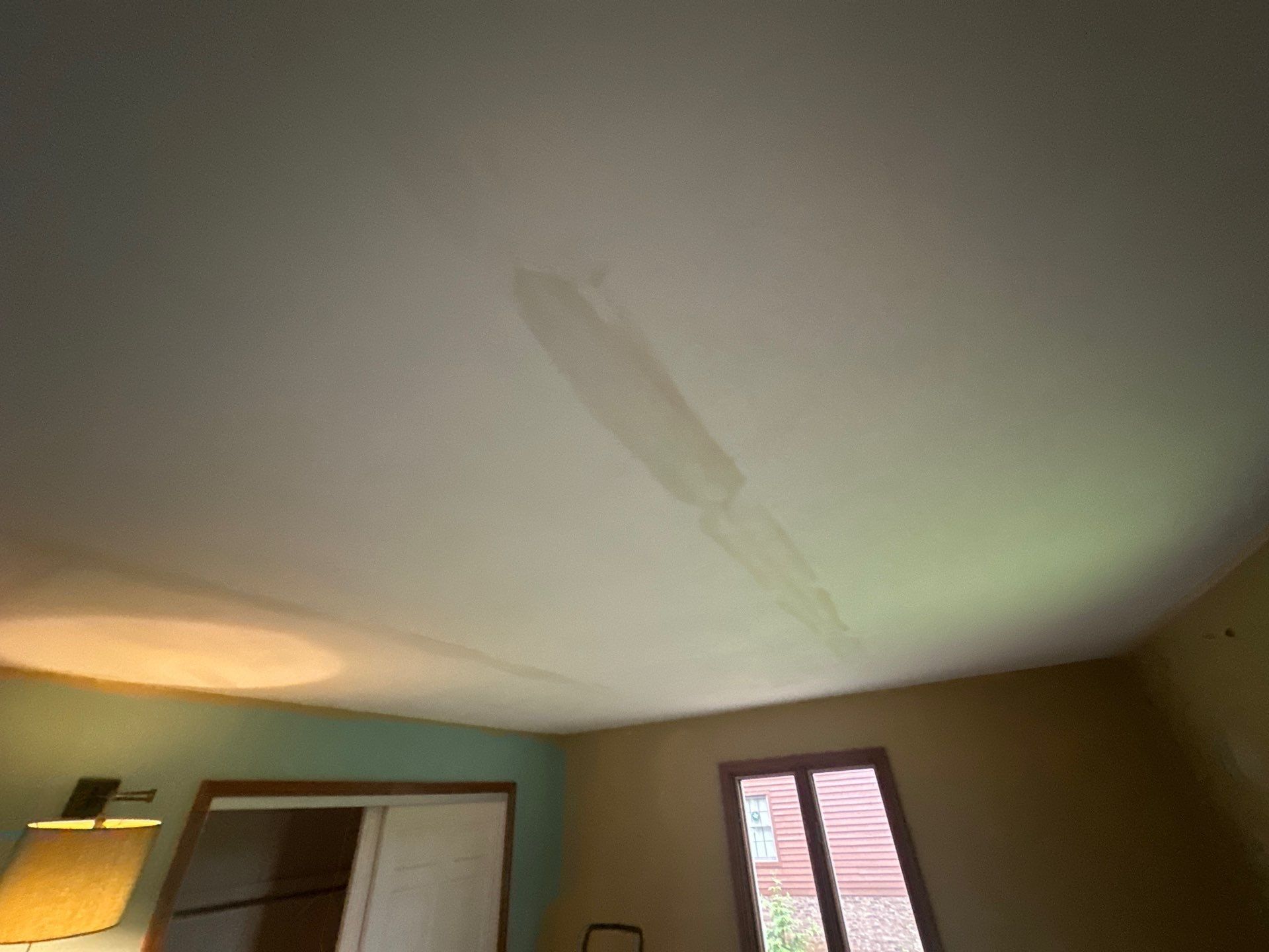Water stains on a ceiling inside the house before the repair, Beavercreek, Ohio.
