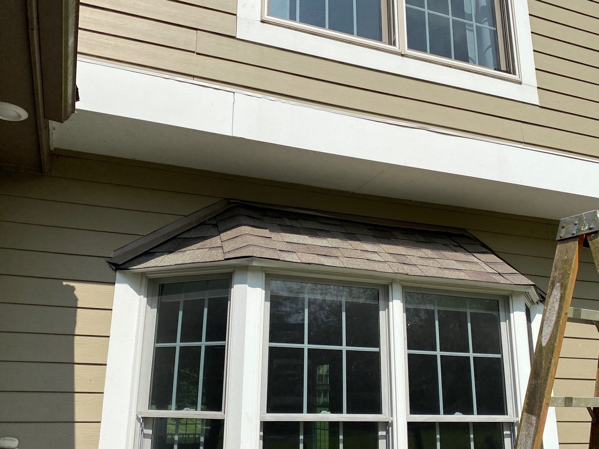 New shingles on the bay window roof below the upstairs windows, Yellow Springs, Ohio.