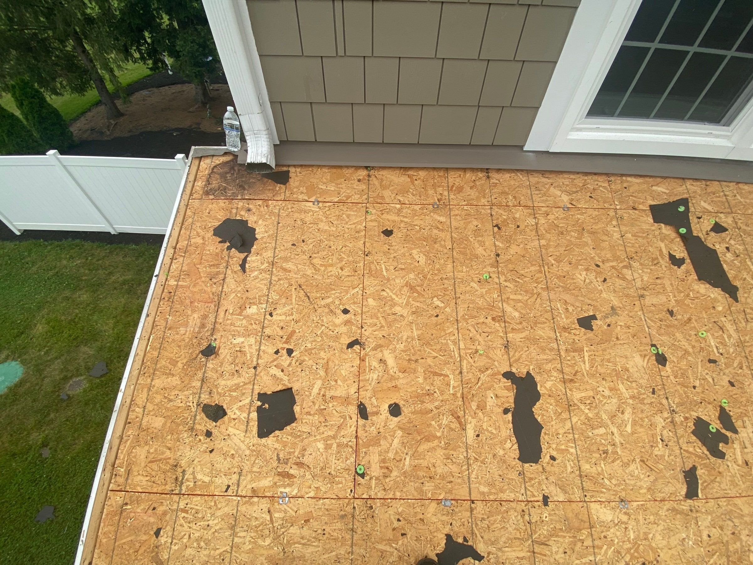 Porch roof deck cleared of old shingles below the second story windows, Yellow Springs, Ohio.