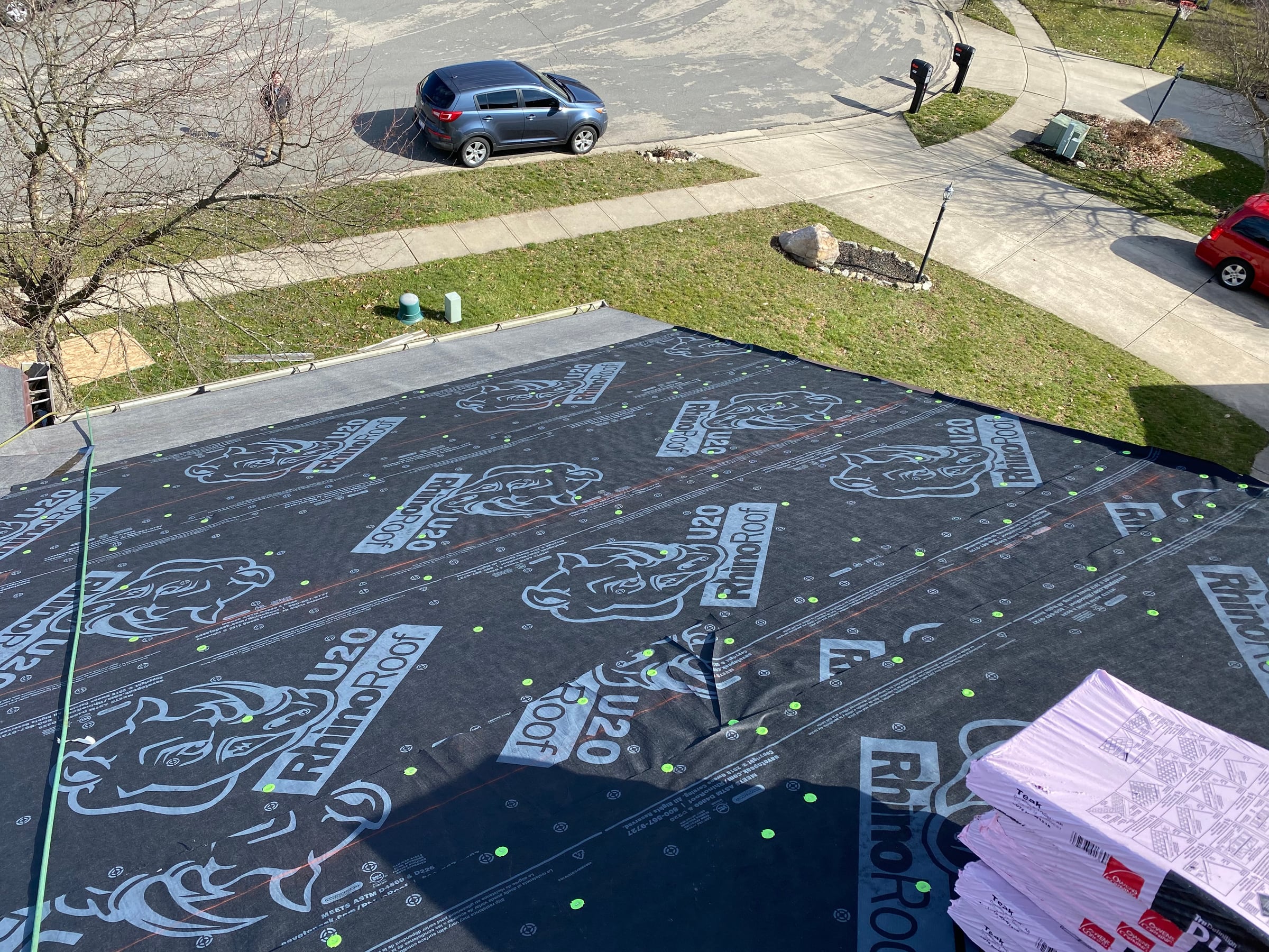 RhinoRoof underlayment covering the front slope, with shingle bundles, Fairborn, Ohio.
