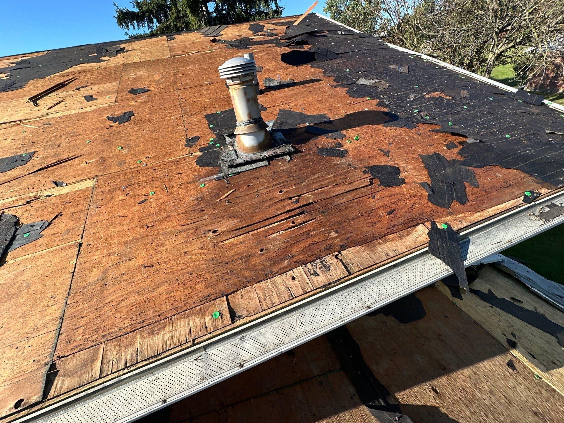 Weathered deck around a vent stack after tear-off, West Carrollton, Ohio.
