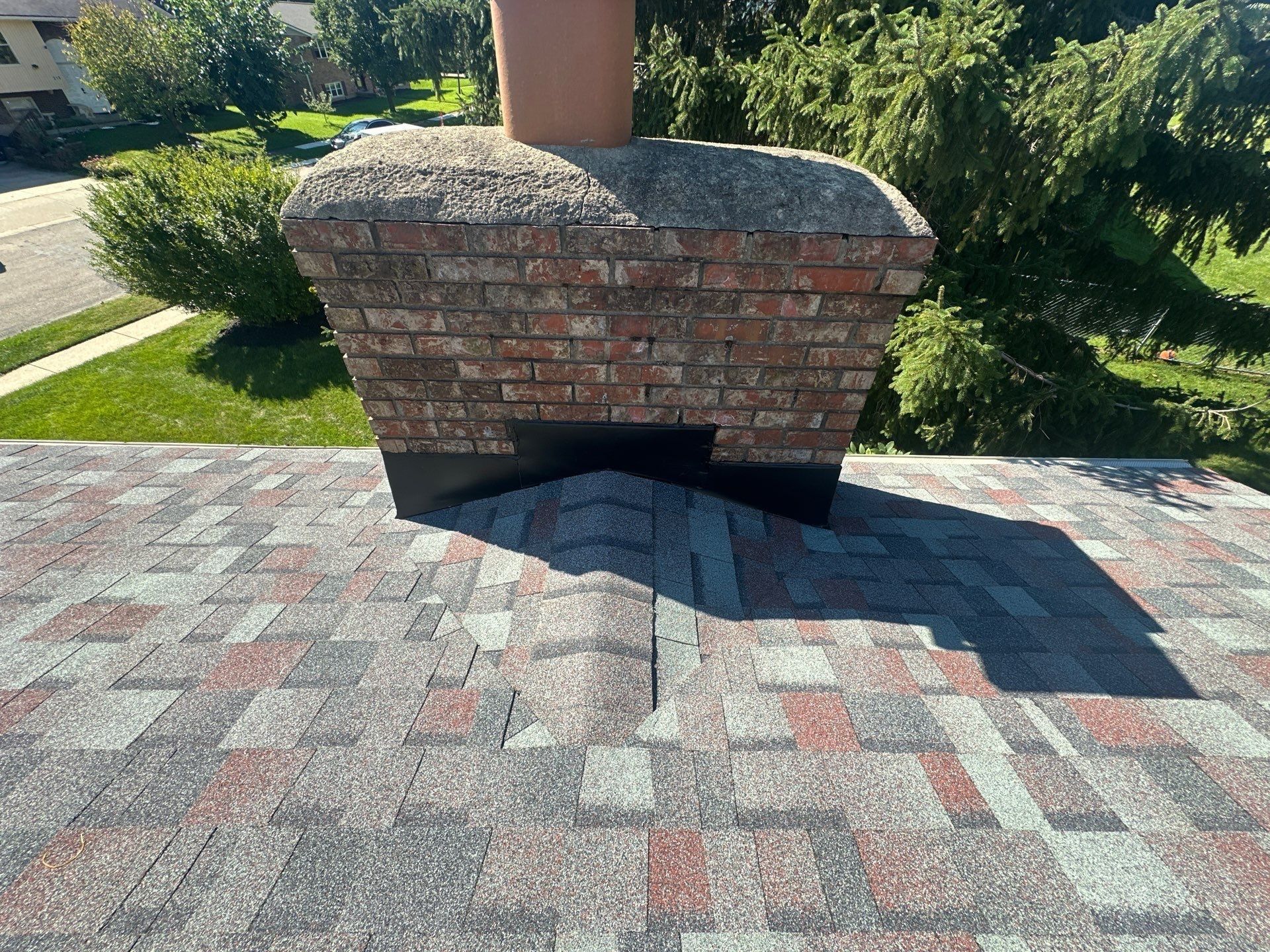 New black flashing across the front of the brick chimney, West Carrollton, Ohio.