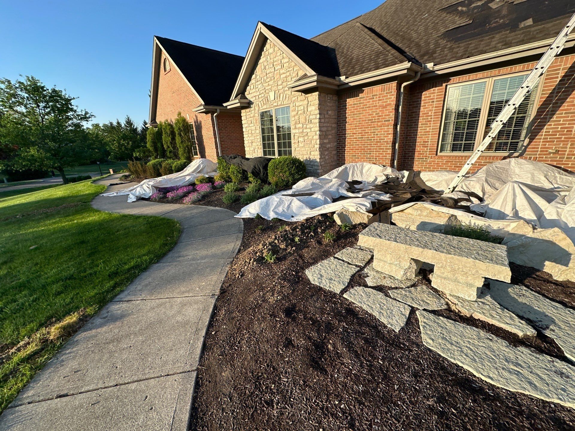 Front planting and stone walk under tarps