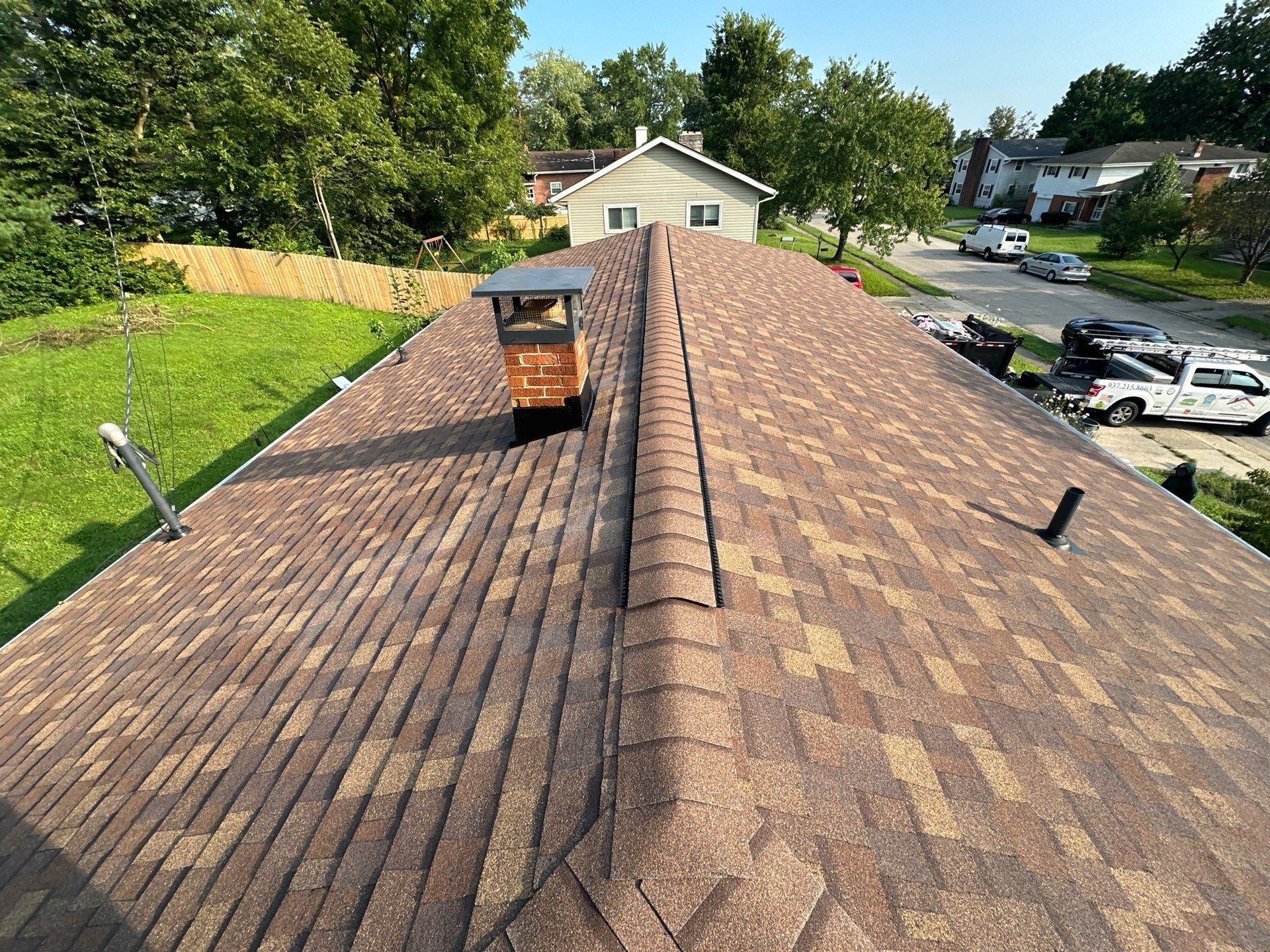 The finished roof, ridge, chimney and vent pipe above the street, Fairborn, Ohio.