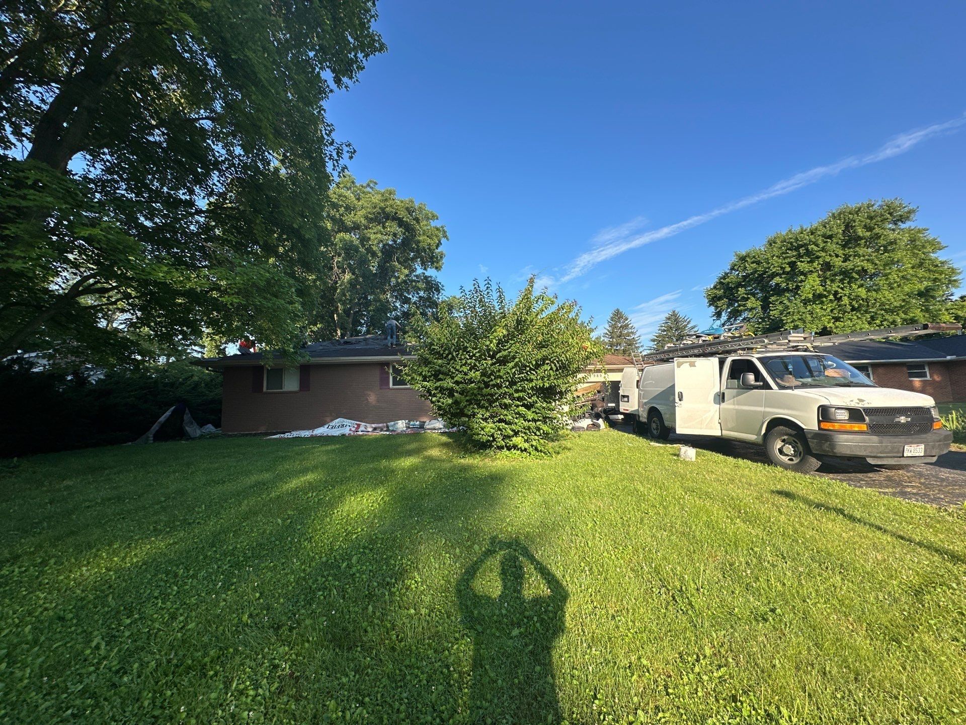 Crew van parked and tarps laid along the house on install morning, Beavercreek, Ohio.