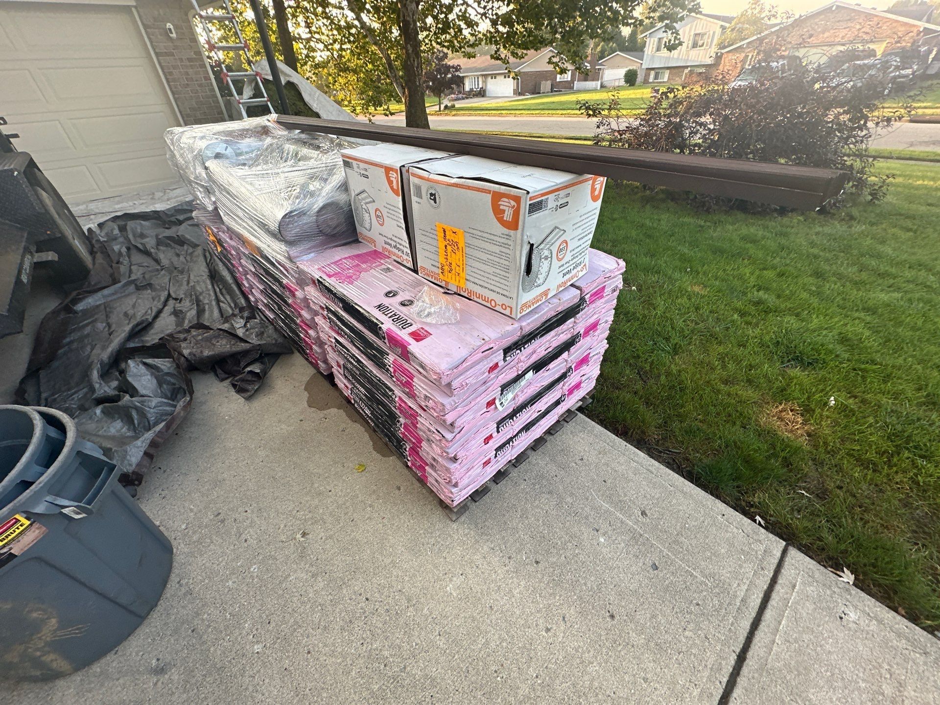 A pallet of Duration shingles and ridge vent boxes at the end of the driveway, Dayton, Ohio.