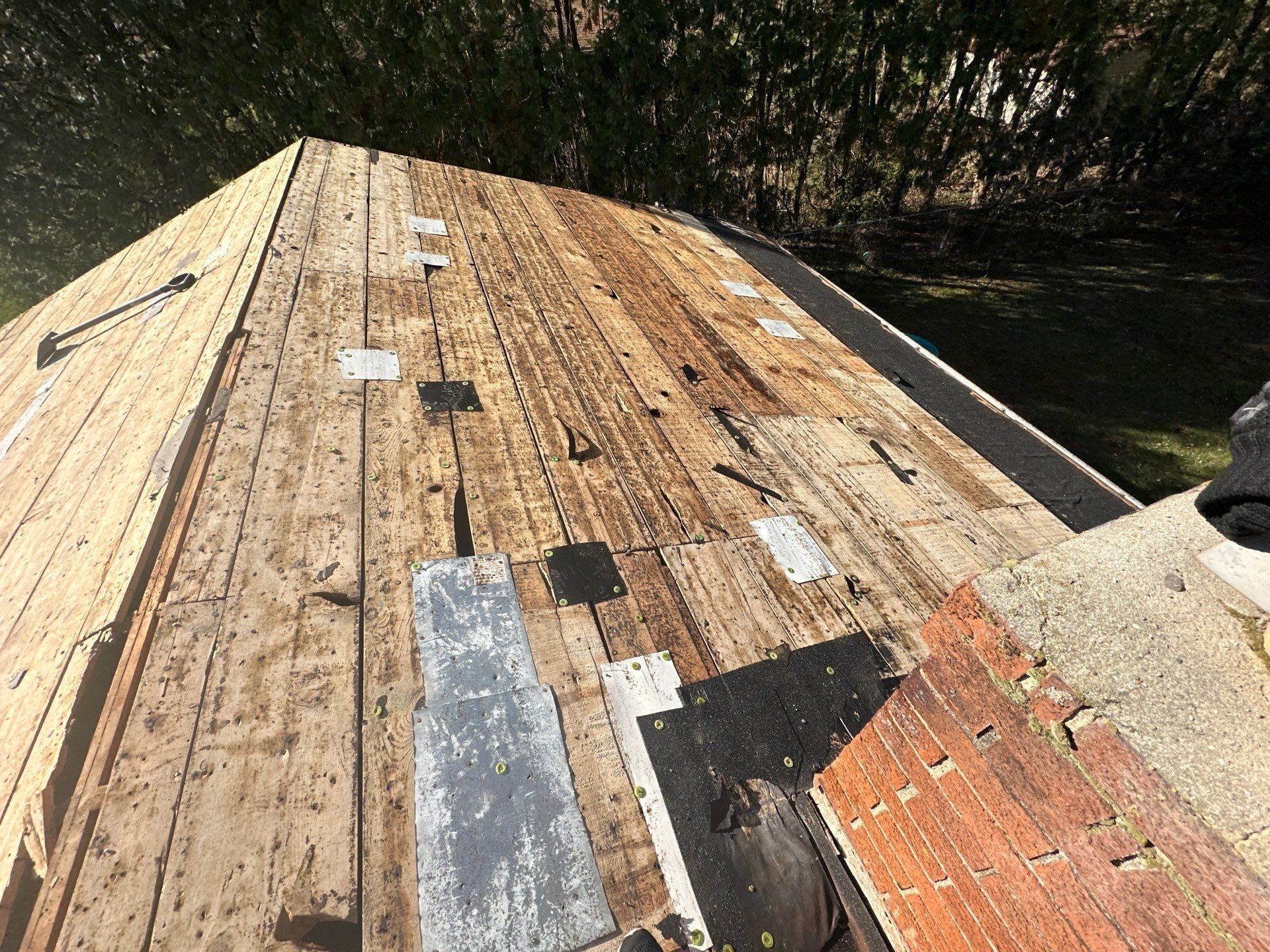 Old spaced planks beside the chimney after tear-off, Beavercreek, Ohio.