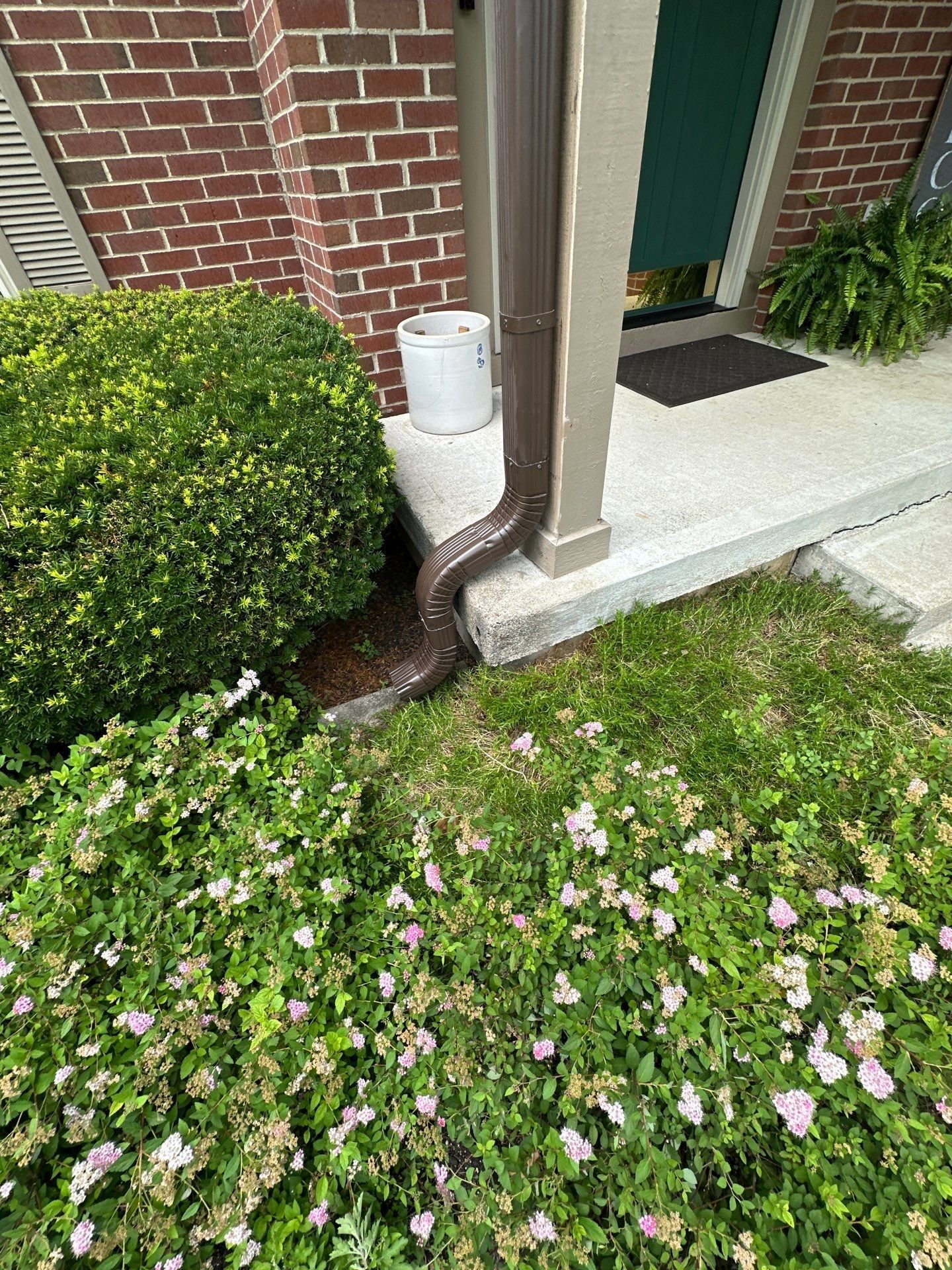Downspout beside the flowering border