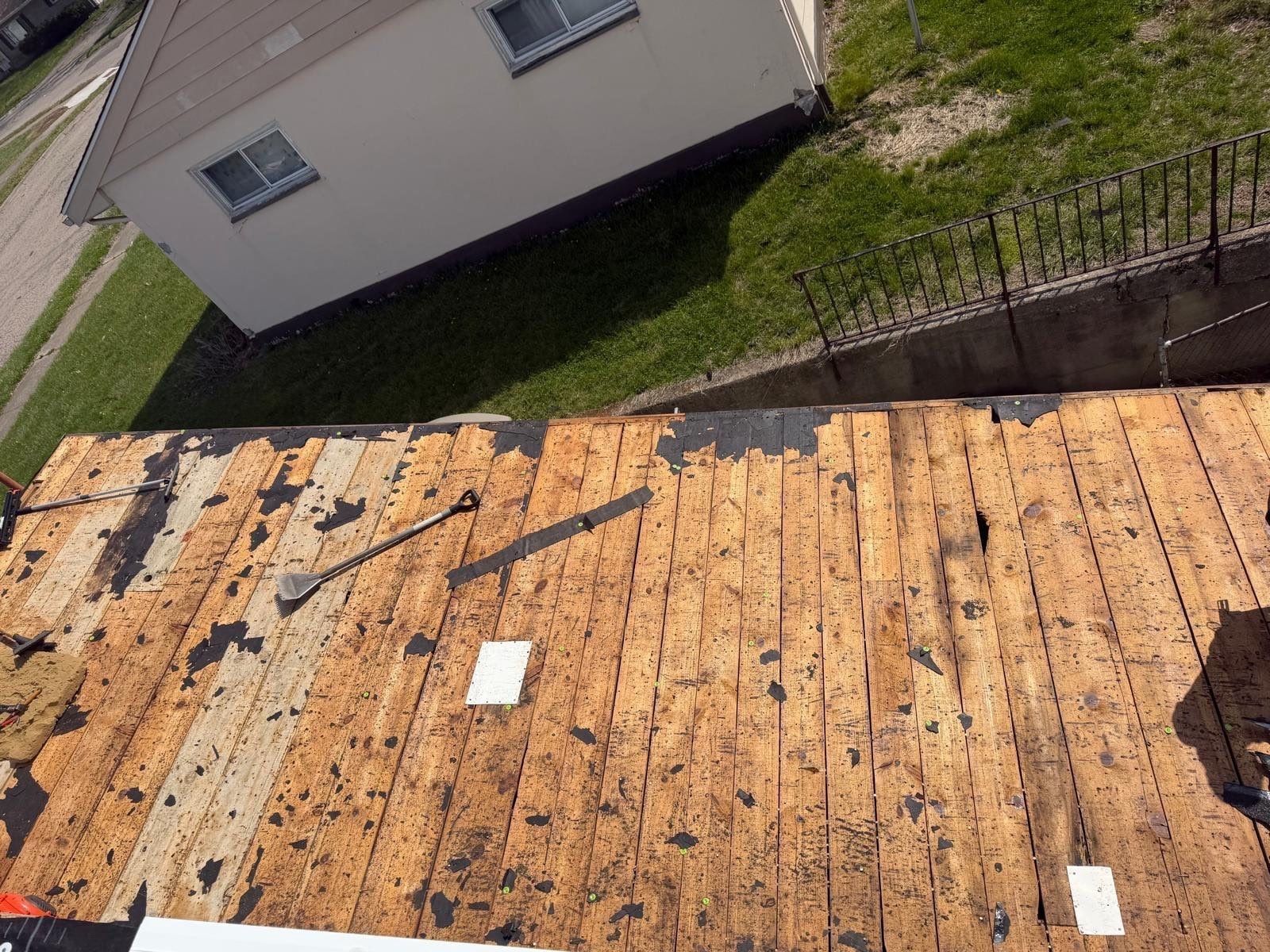 A roof elevation stripped to its original plank decking during a Helping Hands Roofing project in Dayton, Ohio.