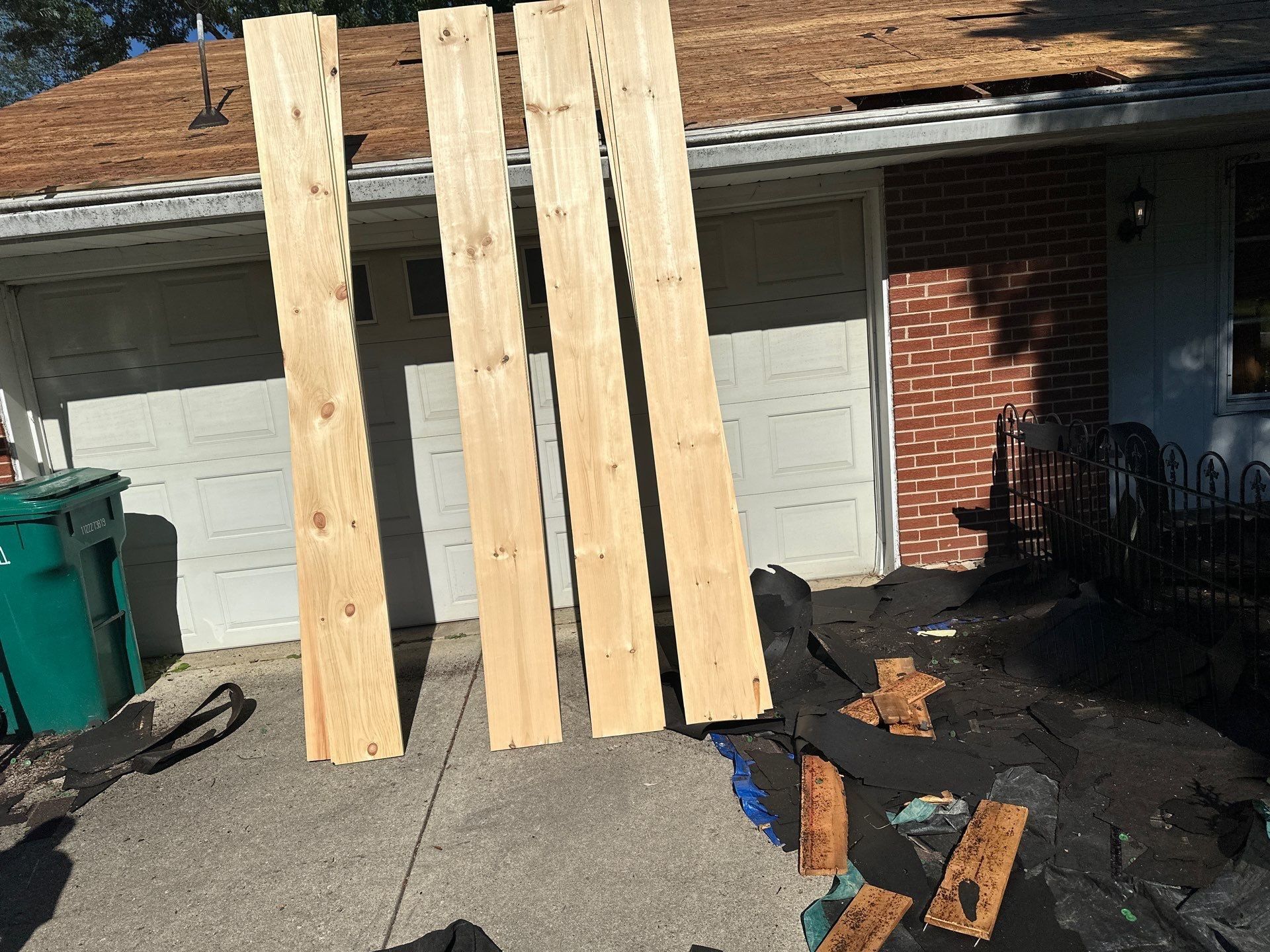 The replacement deck boards leaning on the garage door, Beavercreek, Ohio.