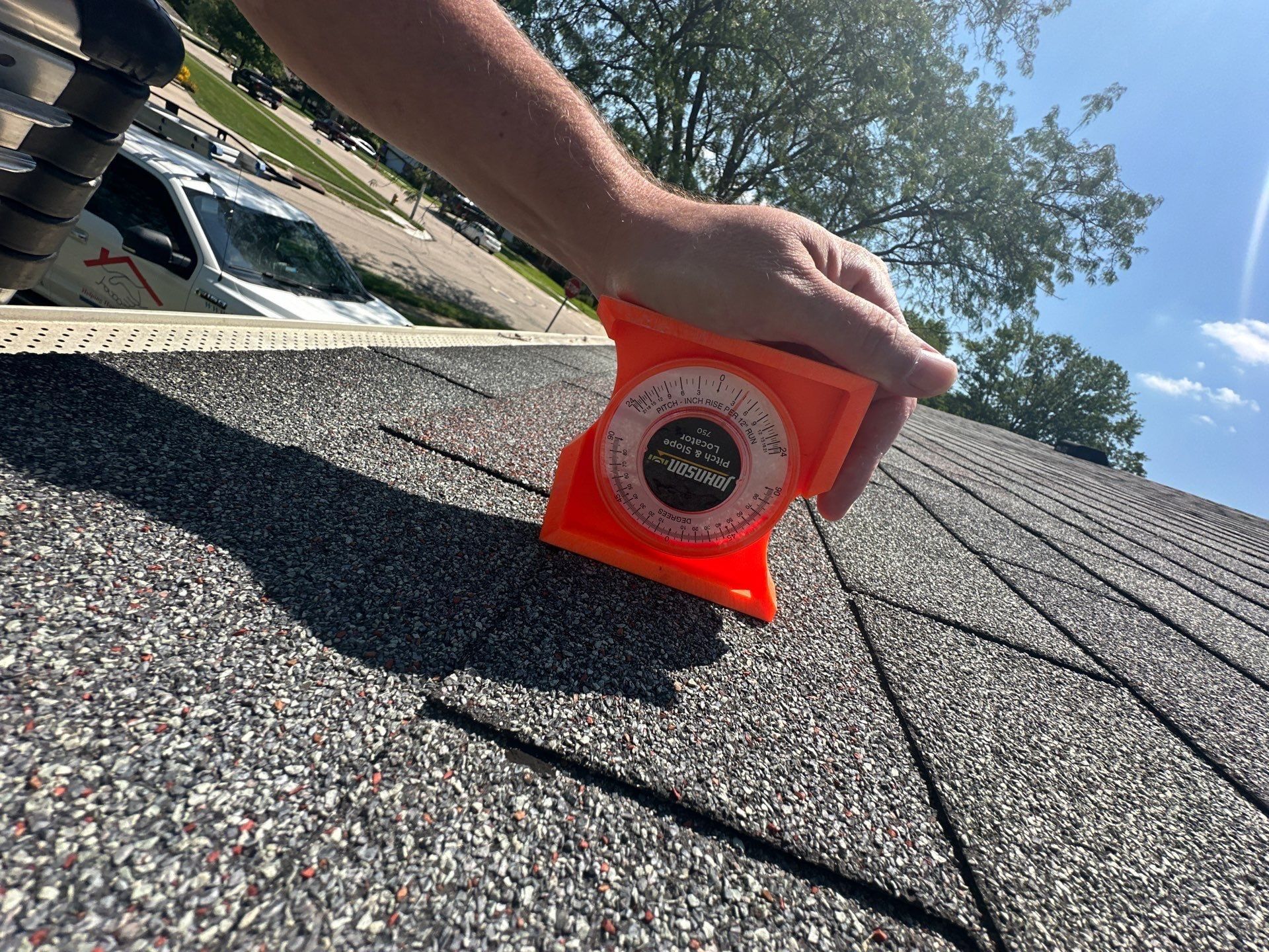 A pitch gauge set on the old shingles to read the slope of the roof, West Carrollton, Ohio.