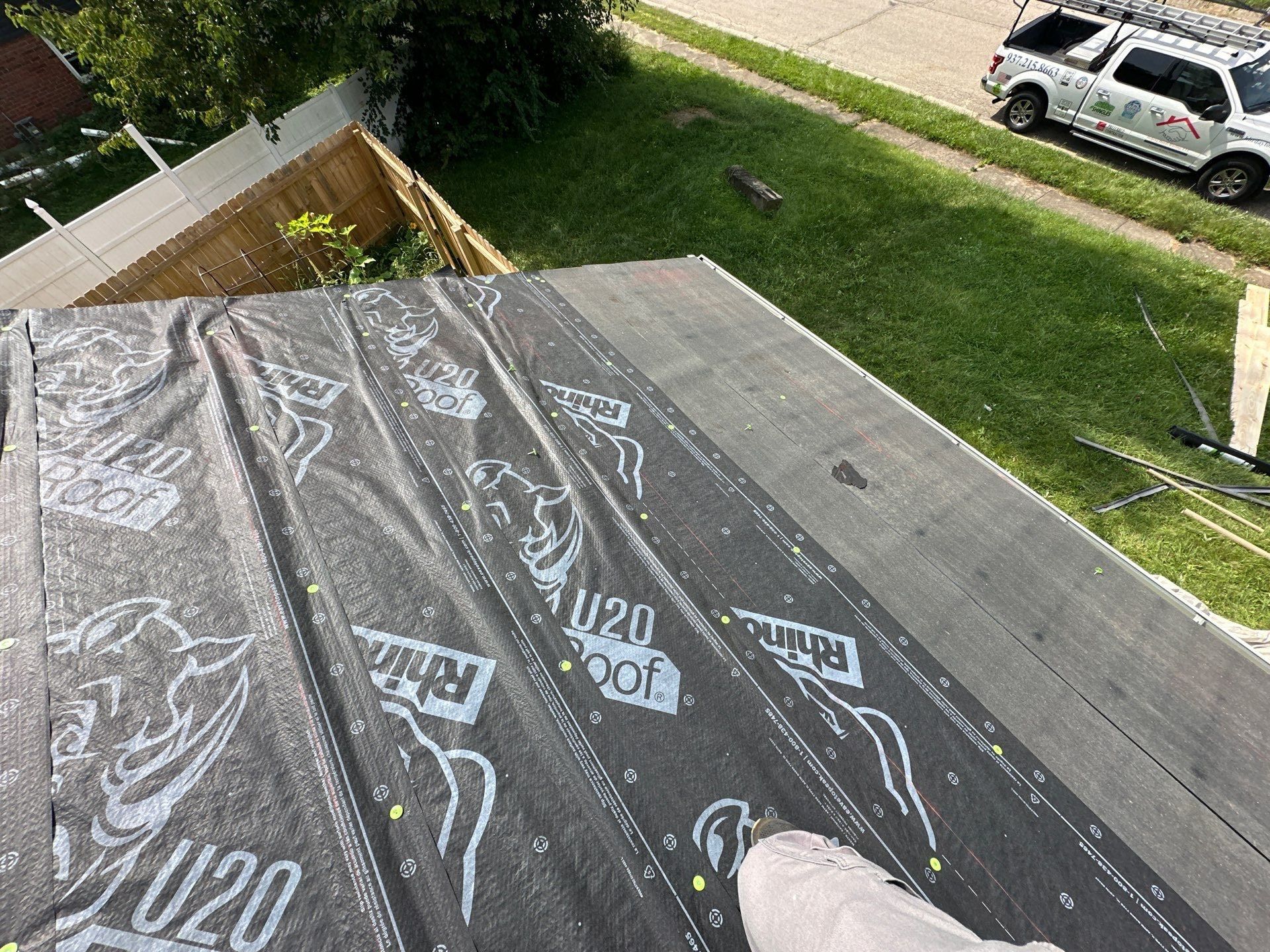 RhinoRoof synthetic underlayment over a lower roof above the fence, Fairborn, Ohio.