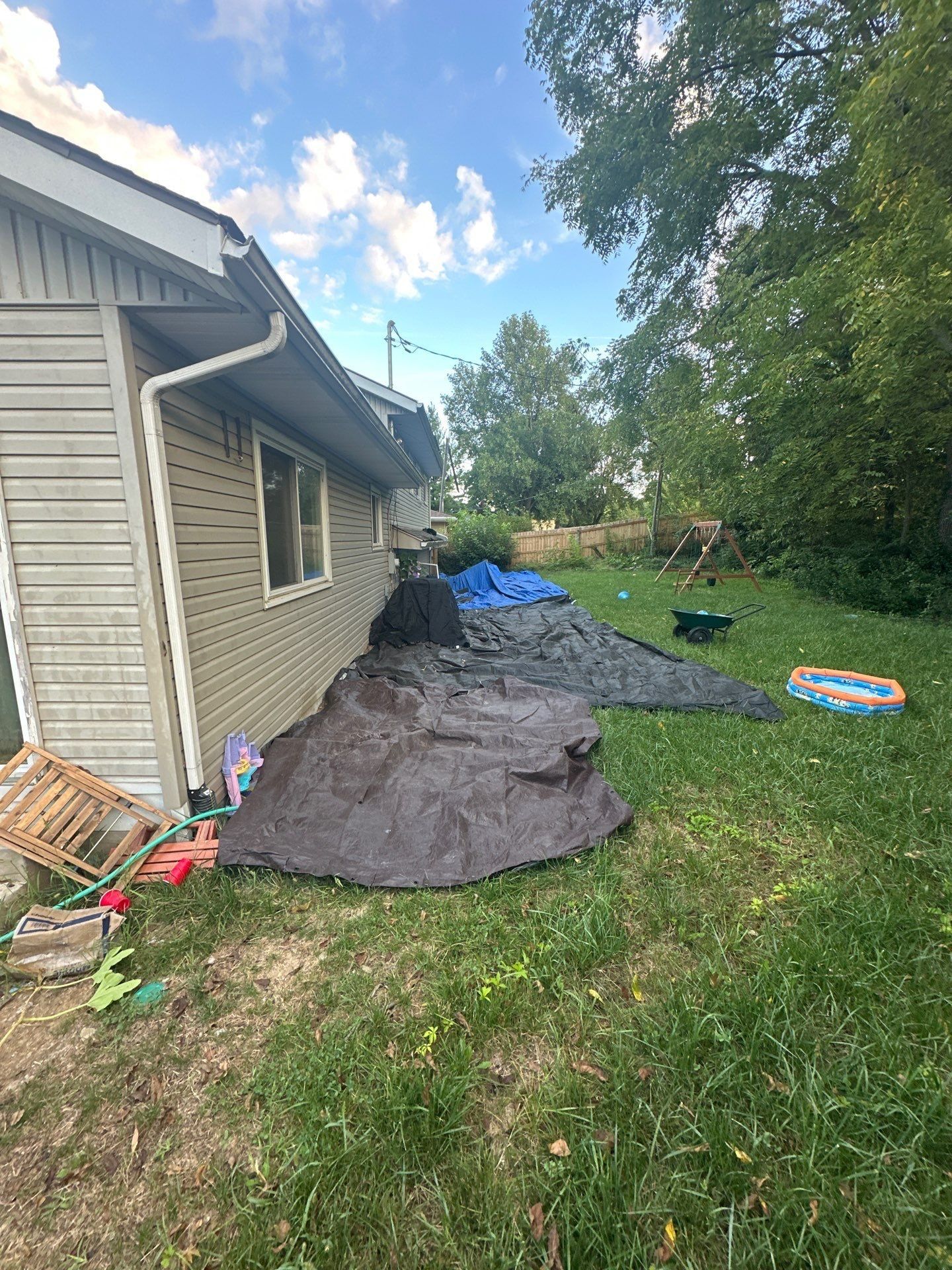 Tarps laid along the side of the house over the lawn, Fairborn, Ohio.