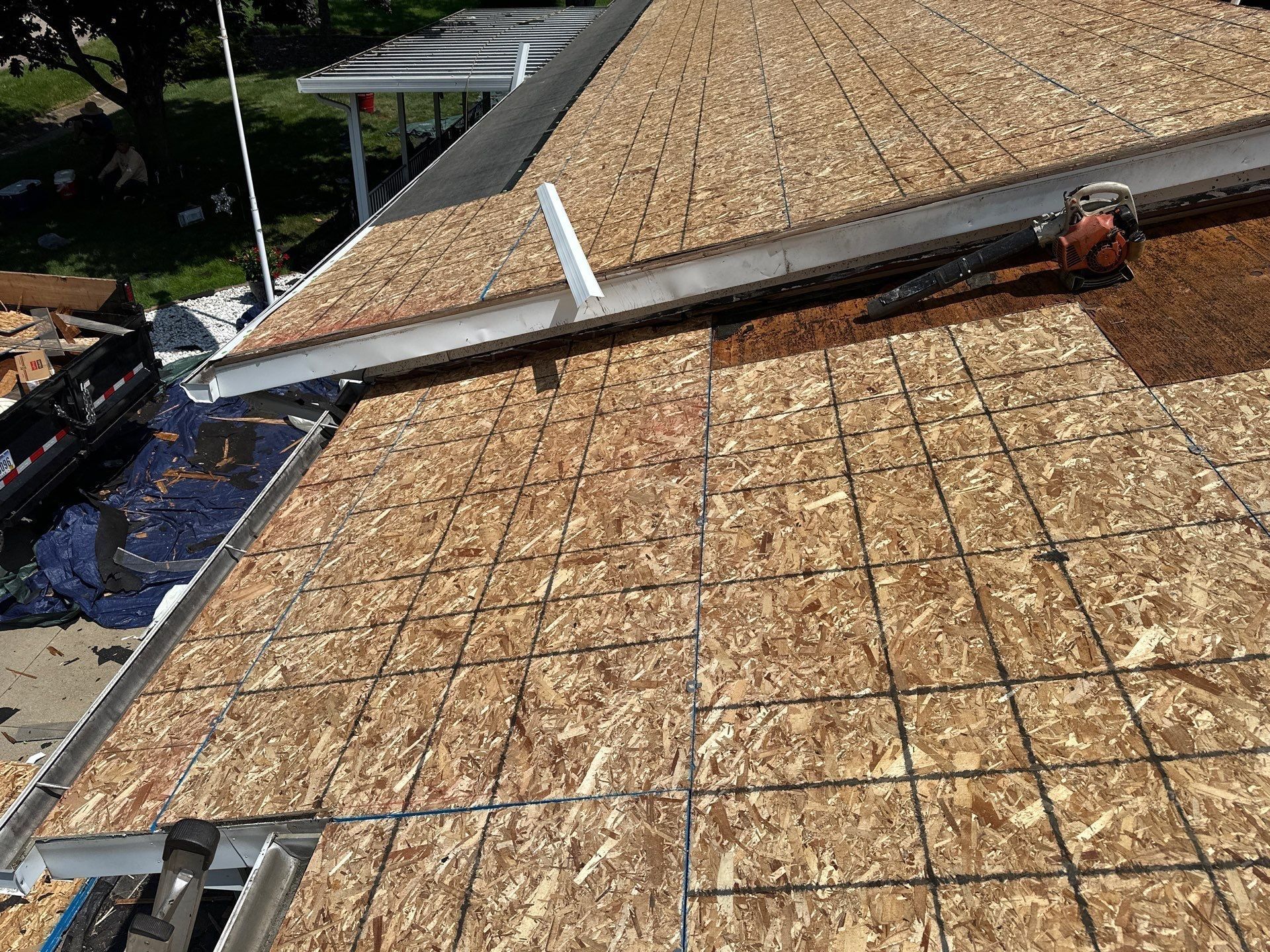 New OSB sheathing meeting the old deck at the roof edge, Beavercreek, Ohio.